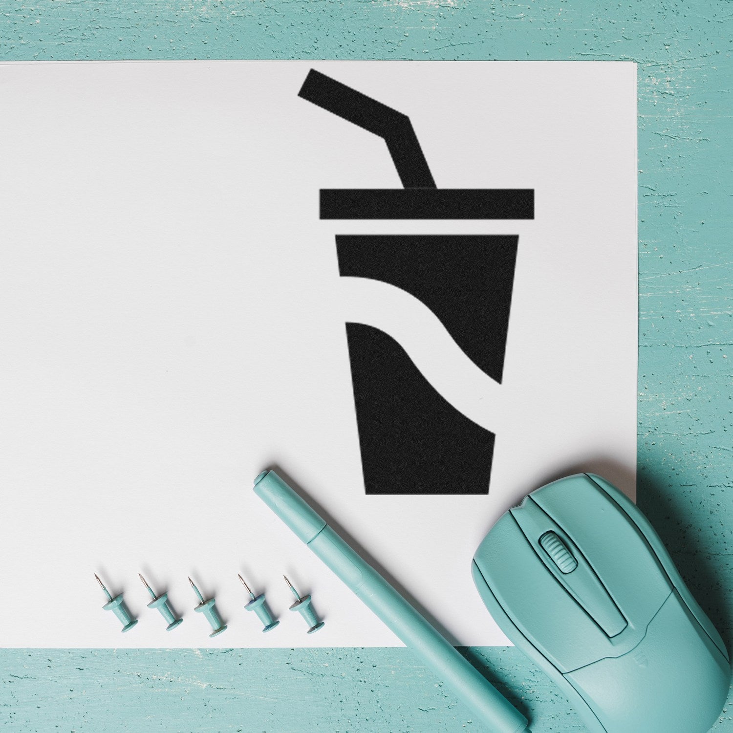 Self-Inking Cool Sip Collection for Rewards Stamp featuring a black drink cup design on white paper, with a teal pen, mouse, and push pins on a turquoise surface.