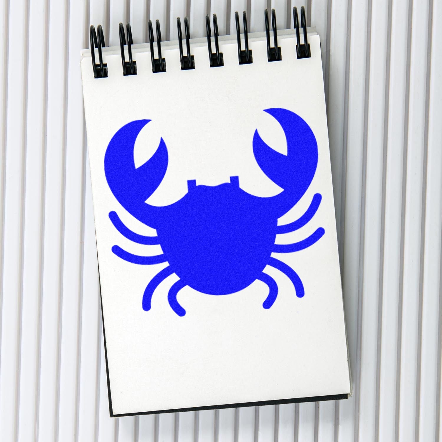 Wood Handle Crabby Rewards Rubber Stamp featuring a blue crab design on a notepad, showcasing its detailed imprint and sturdy wooden handle.