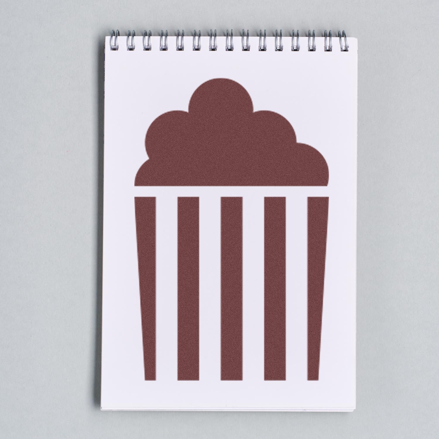 Wood Handle Popped Punch Card Rubber Stamp on a notepad, featuring a popcorn bucket design. Ideal for crafting and decoration.