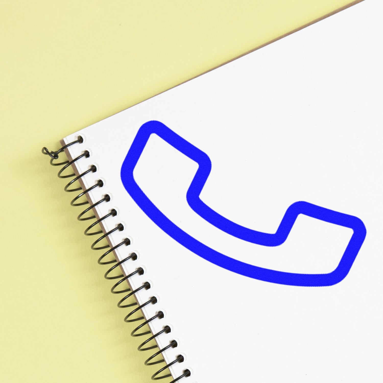 Image of a Self-Inking Call & Collect for Free Item Stamp on a spiral notebook, featuring a blue phone icon. Perfect for businesses offering call and collect services.