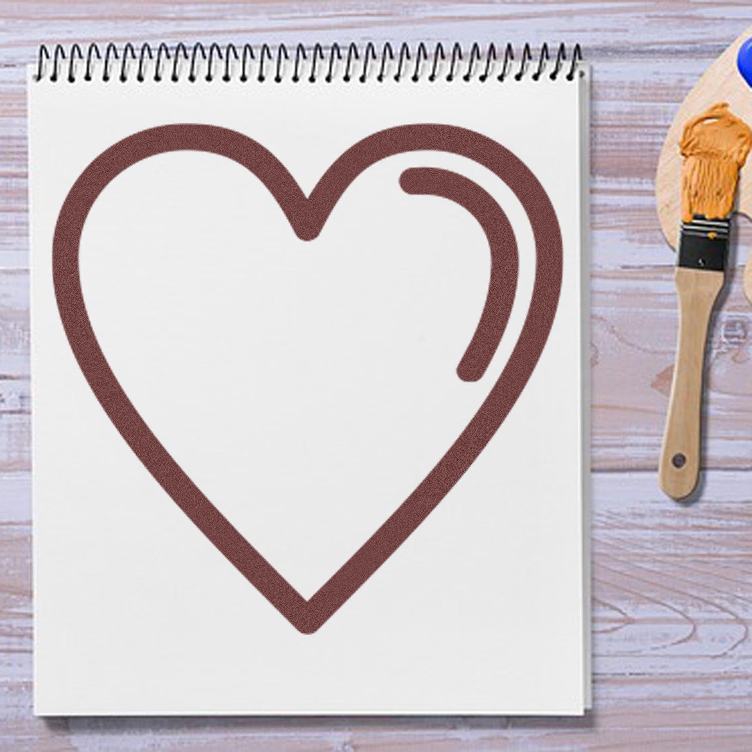 Wood Handle Heartfelt Loyalty Rubber Stamp on a notepad, showcasing a heart design. Perfect for crafting and personalizing projects.