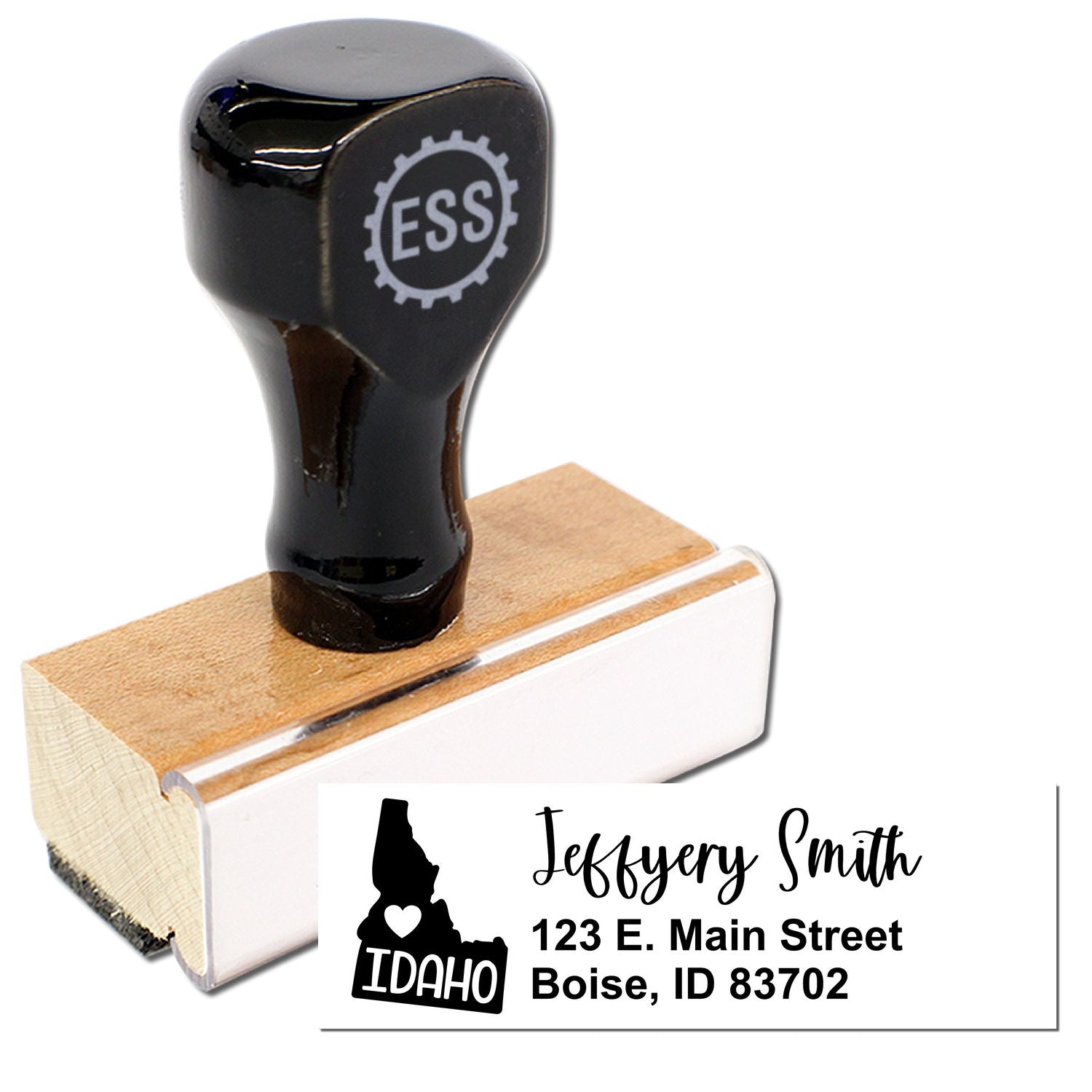 Image of the Idaho State Love Personalized Address Stamp with a wooden base and black handle. The stamp imprint shows Jeffery Smith, 123 E. Main Street, Boise, ID 83702 with an Idaho state outline.