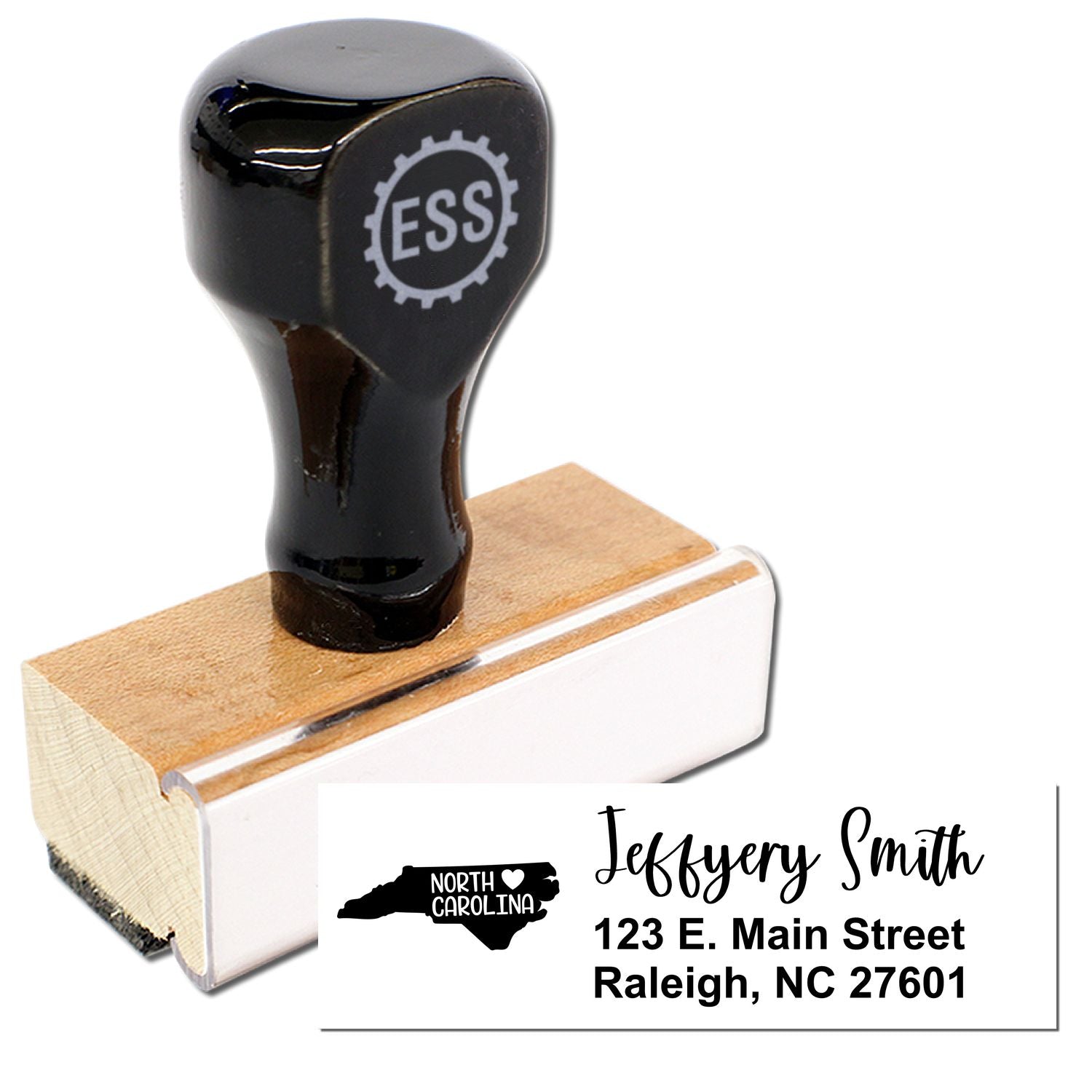 Image of a North Carolina State Love Personalized Address Stamp with a wooden base and black handle, featuring a sample address: Jeffery Smith, 123 E. Main Street, Raleigh, NC 27601.