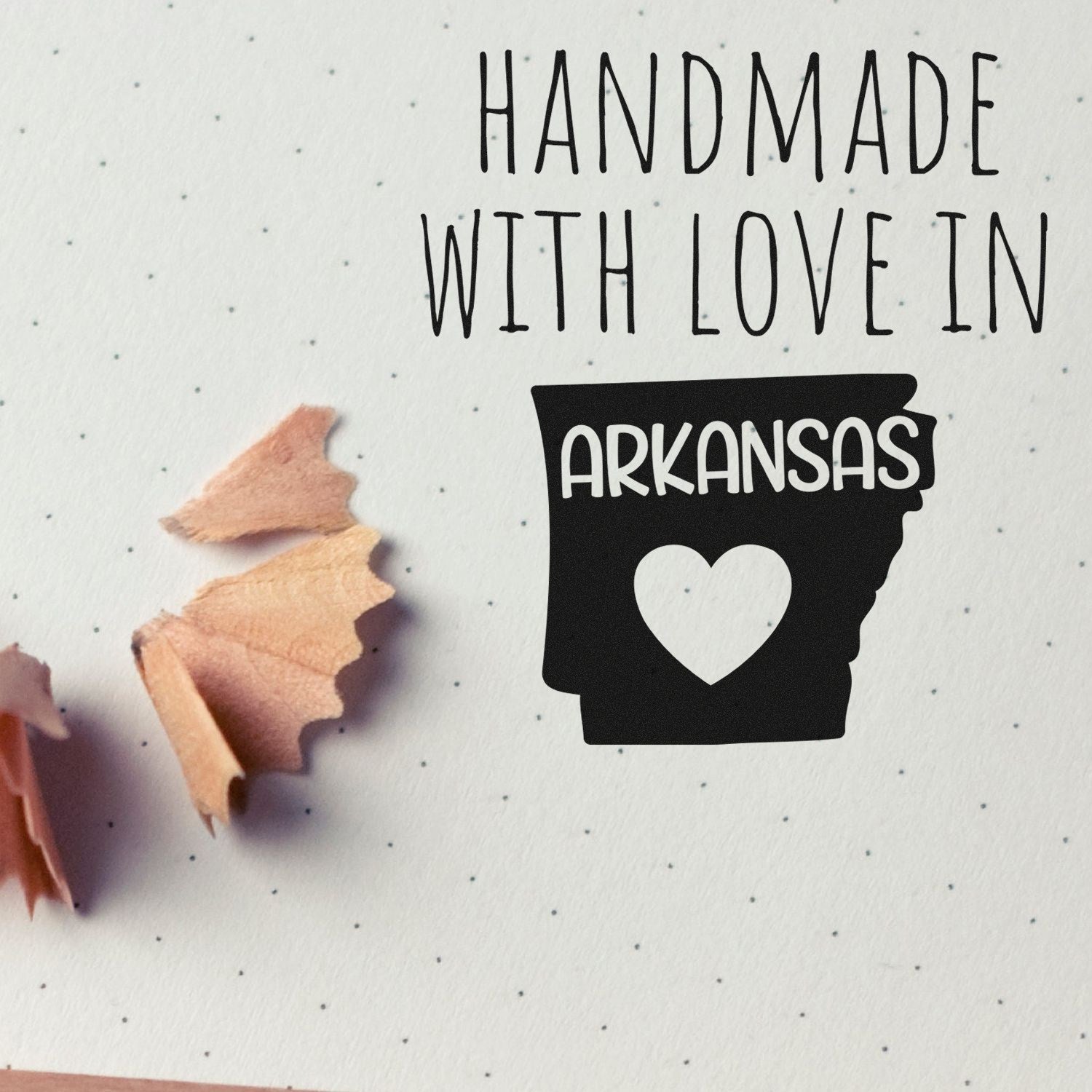 Wood Handle Arkansas Handmade with Love Rubber Stamp on paper with pencil shavings, featuring a heart and 'Arkansas' text, showcasing craftsmanship and love.