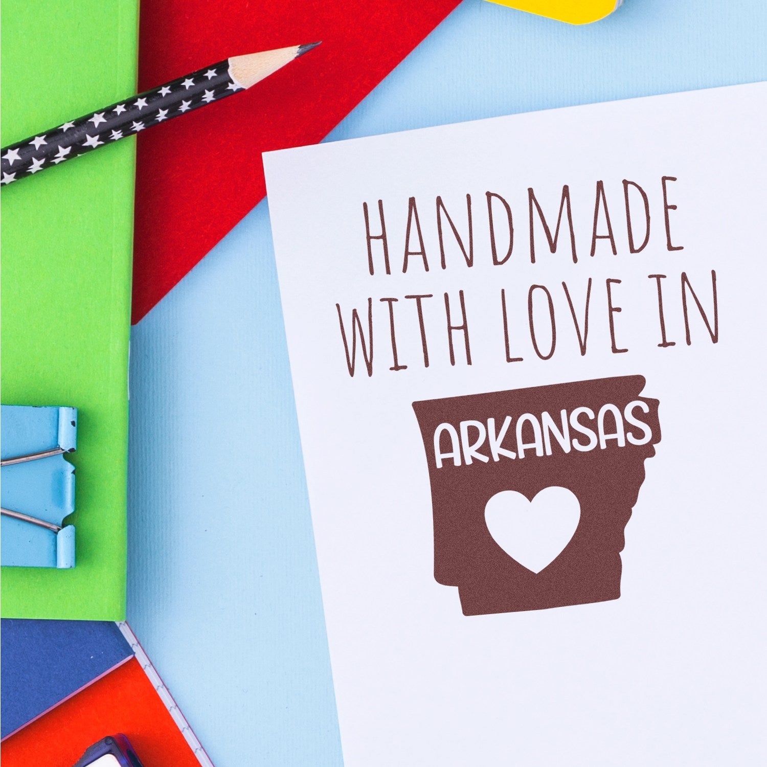 Self-Inking Arkansas Handmade with Love Stamp on colorful paper background, featuring a heart and state outline design, perfect for crafts and gifts.