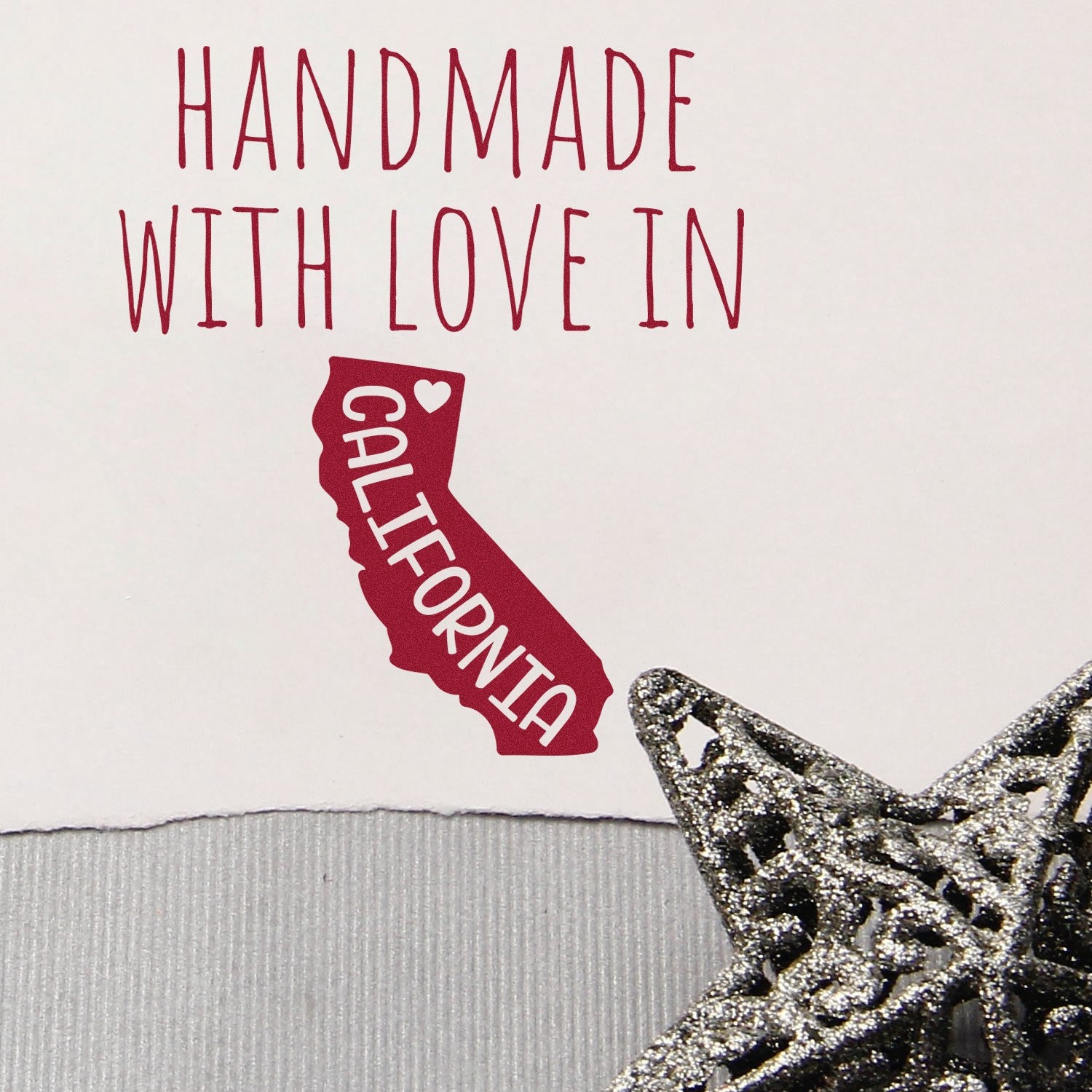 Self-Inking California Handmade with Love Stamp featuring a red California outline with text Handmade with Love in California and a decorative silver star. Perfect for crafts and gifts.