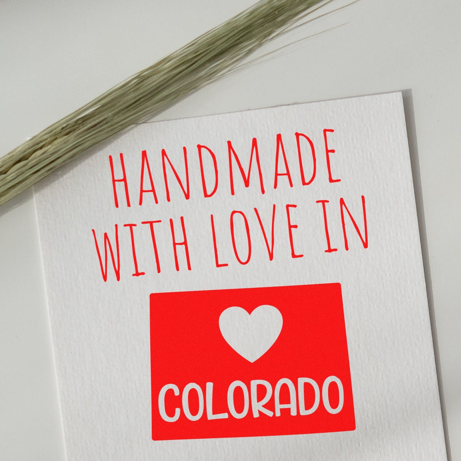 PSI Pre-Inked Handmade with Love in Colorado stamp on white paper with red text and heart graphic, showcasing craftsmanship and local pride.