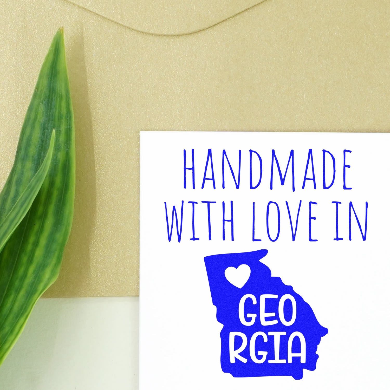 Self-Inking Georgia Handmade with Love Stamp featuring a blue Georgia state outline and 'Handmade with Love in Georgia' text, perfect for crafts and gifts.