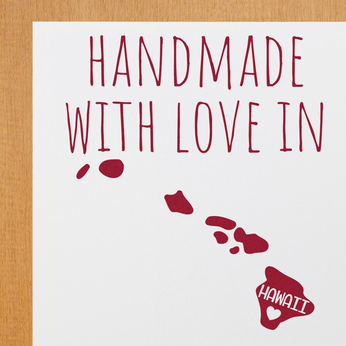 Self-Inking Hawaii Handmade with Love Stamp on paper, featuring red text and a heart-shaped design of the Hawaiian Islands. Perfect for crafts and personalized gifts.