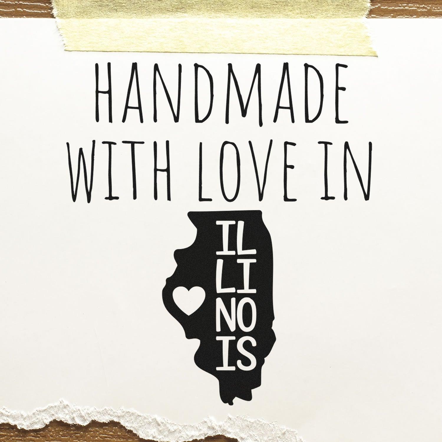 Self-Inking Illinois Handmade with Love Stamp featuring a black Illinois state outline with a heart, and text 'Handmade with Love in Illinois' on a torn paper background.