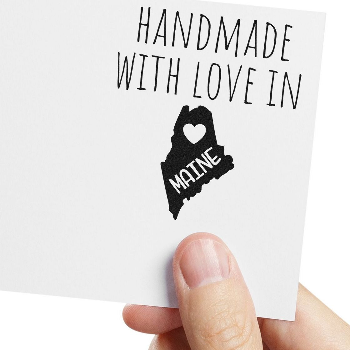 Wood Handle Maine Handmade with Love Rubber Stamp imprint on white paper, featuring a heart and the word 'Maine' inside the state outline.