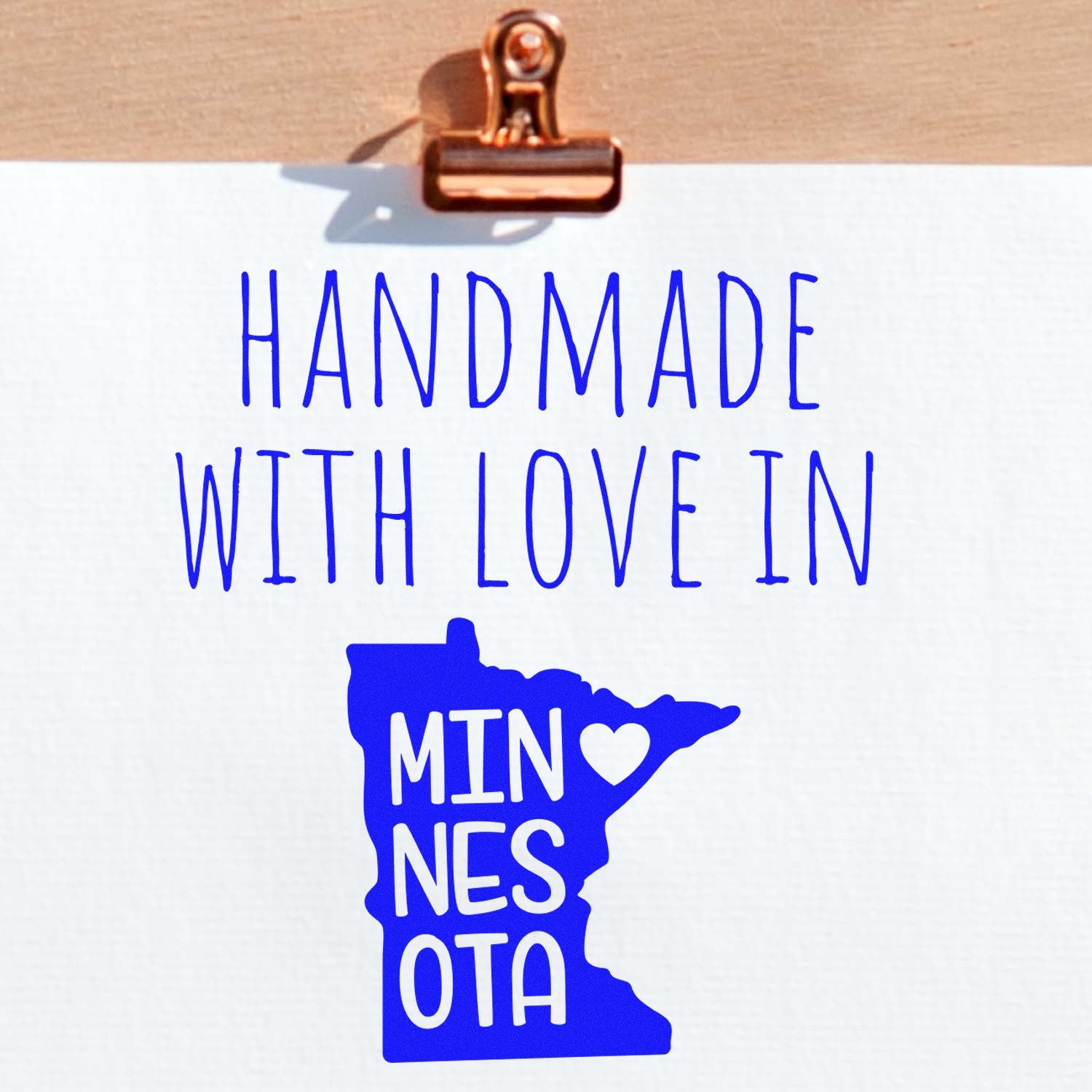 Self-Inking Minnesota Handmade with Love Stamp featuring a blue Minnesota state outline with a heart, perfect for adding a personal touch to crafts and gifts.