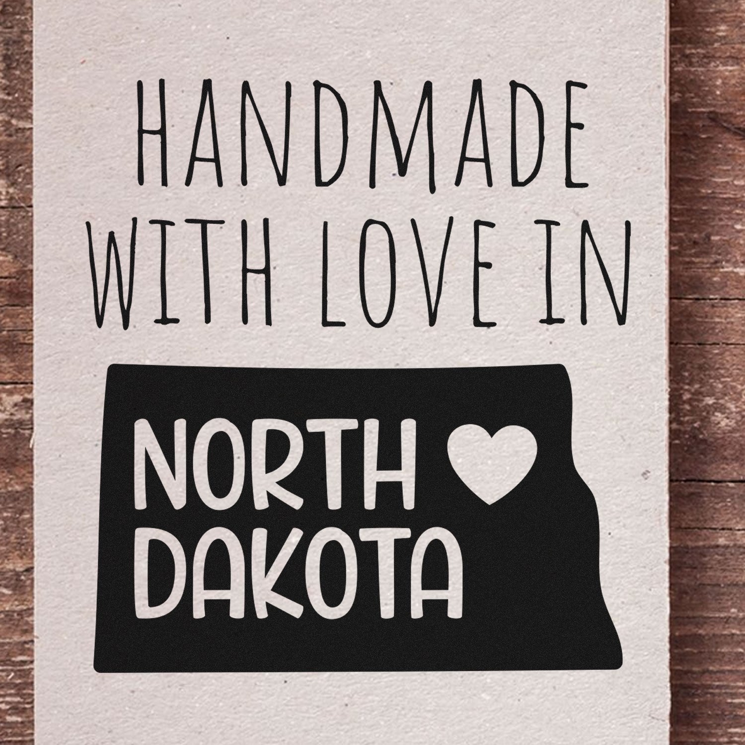 Self-Inking North Dakota Handmade with Love Stamp featuring a heart and state outline on a rustic background, perfect for crafts and gifts.