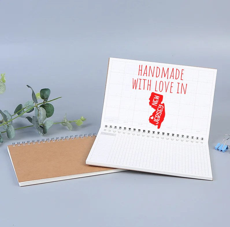 Wood Handle New Jersey Handmade with Love Rubber Stamp on open notebook, showcasing red Handmade with Love in New Jersey imprint. Perfect for crafts and personalized projects.