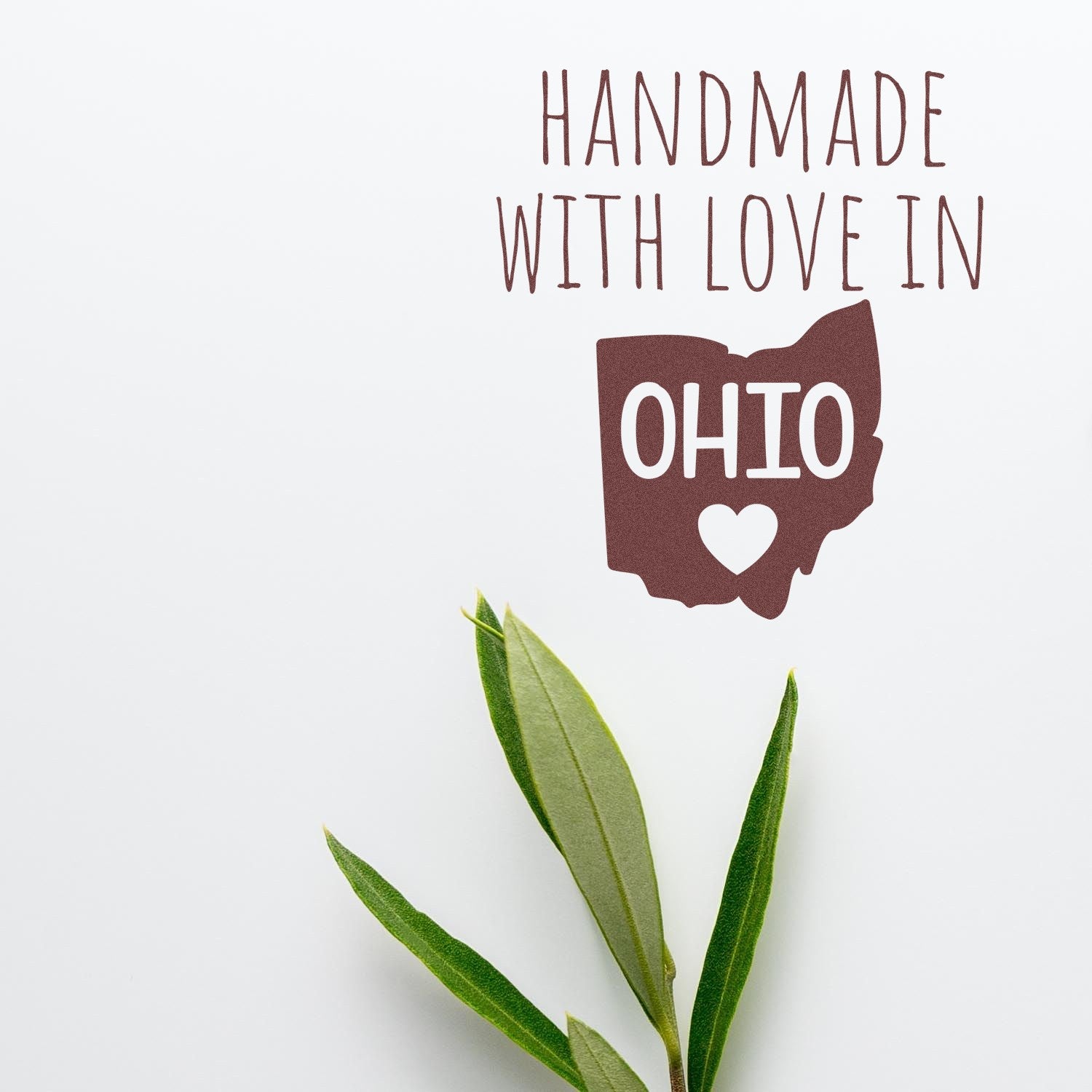 Wood Handle Ohio Handmade with Love Rubber Stamp featuring a heart design inside the state outline, perfect for crafts and gifts. Elegant and rustic, ideal for personalizing projects.