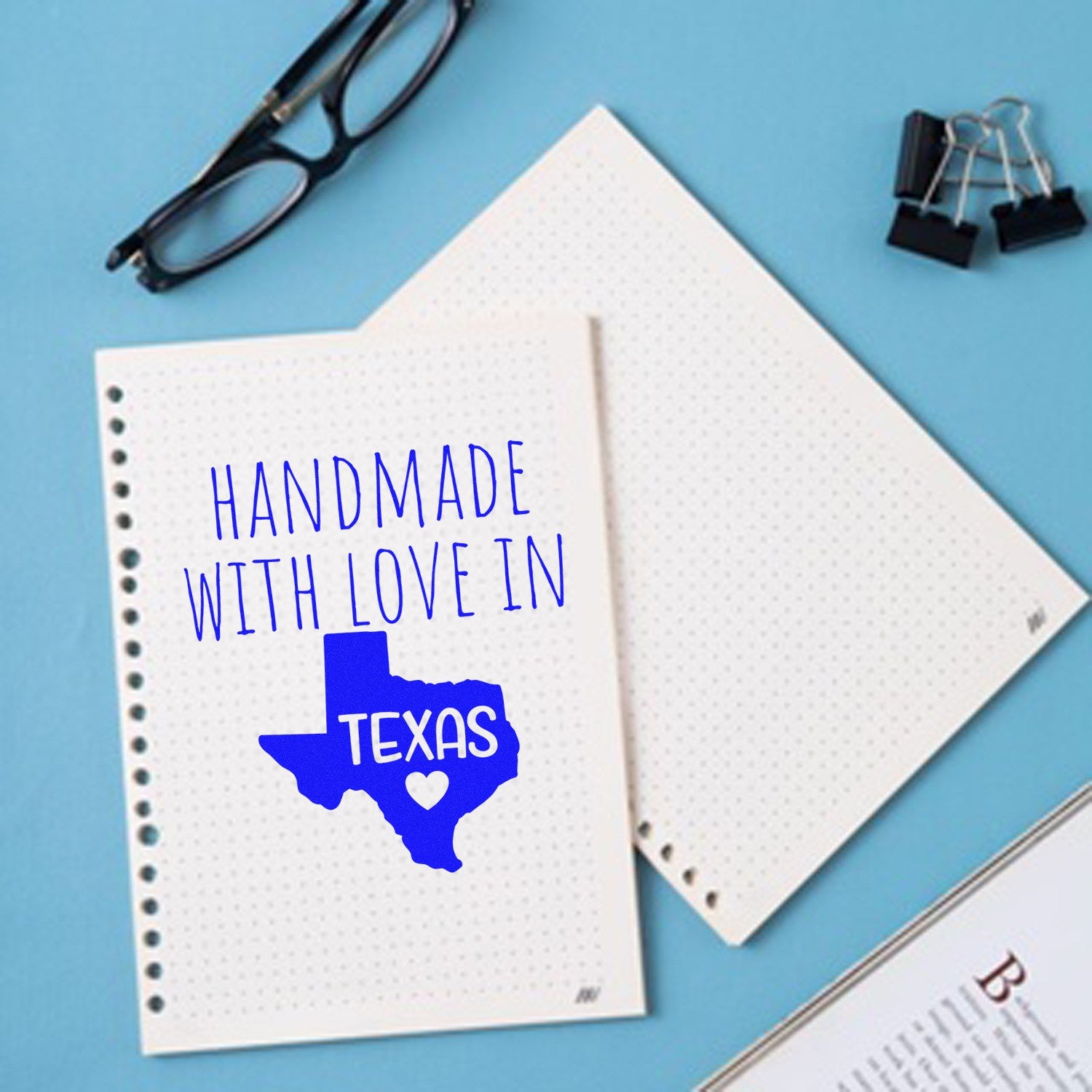 Self-Inking Texas Handmade with Love Stamp on dotted paper, featuring a blue Texas outline with Handmade with Love in Texas text. Ideal for crafts and personalized projects.