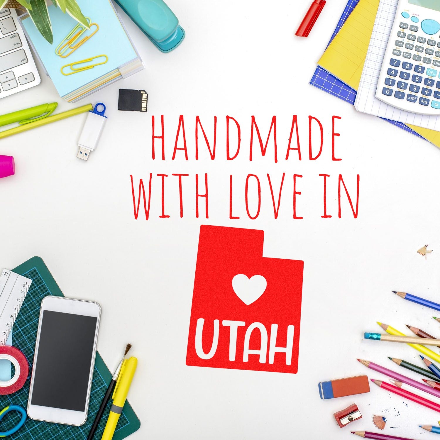 Handmade with Love in Utah Slim Pre-Inked Stamp on a creative desk with colorful stationery, showcasing its red design and heart motif.