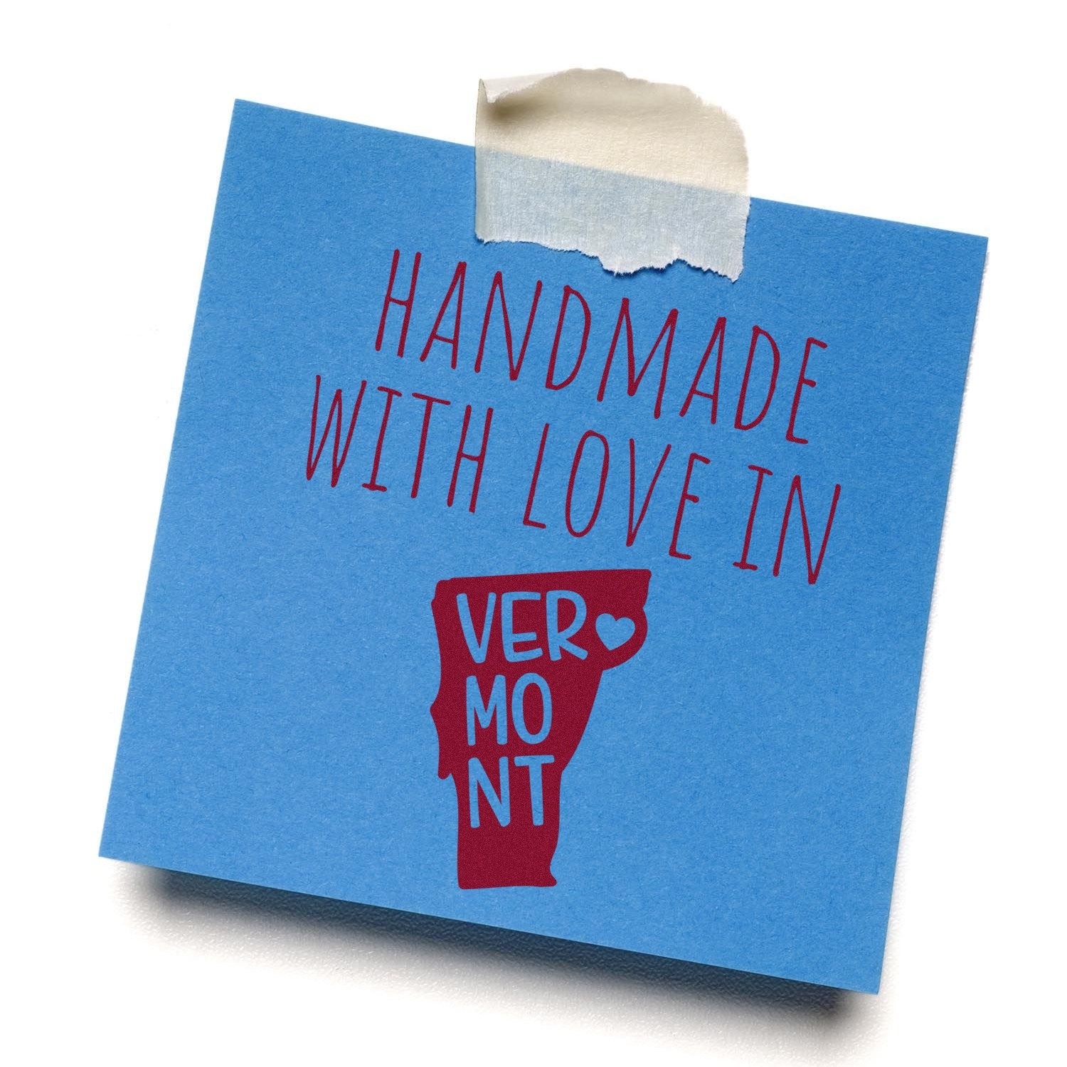 Wood Handle Vermont Handmade with Love Rubber Stamp on blue paper, featuring red text and a Vermont state outline with a heart. Perfect for crafts and personalized projects.