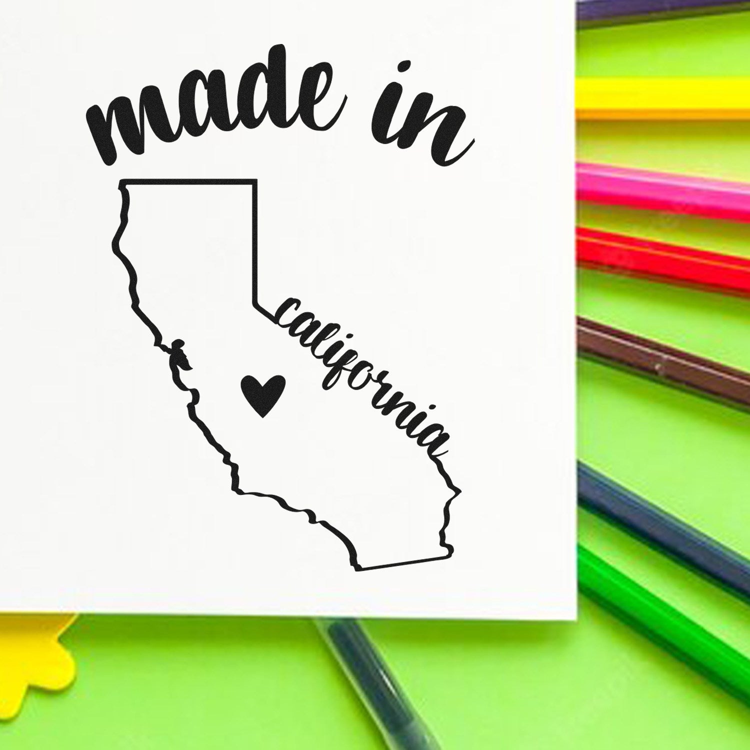 Self-Inking Handmade with Love in California Stamp featuring a map outline with heart, surrounded by colorful markers on a green background.