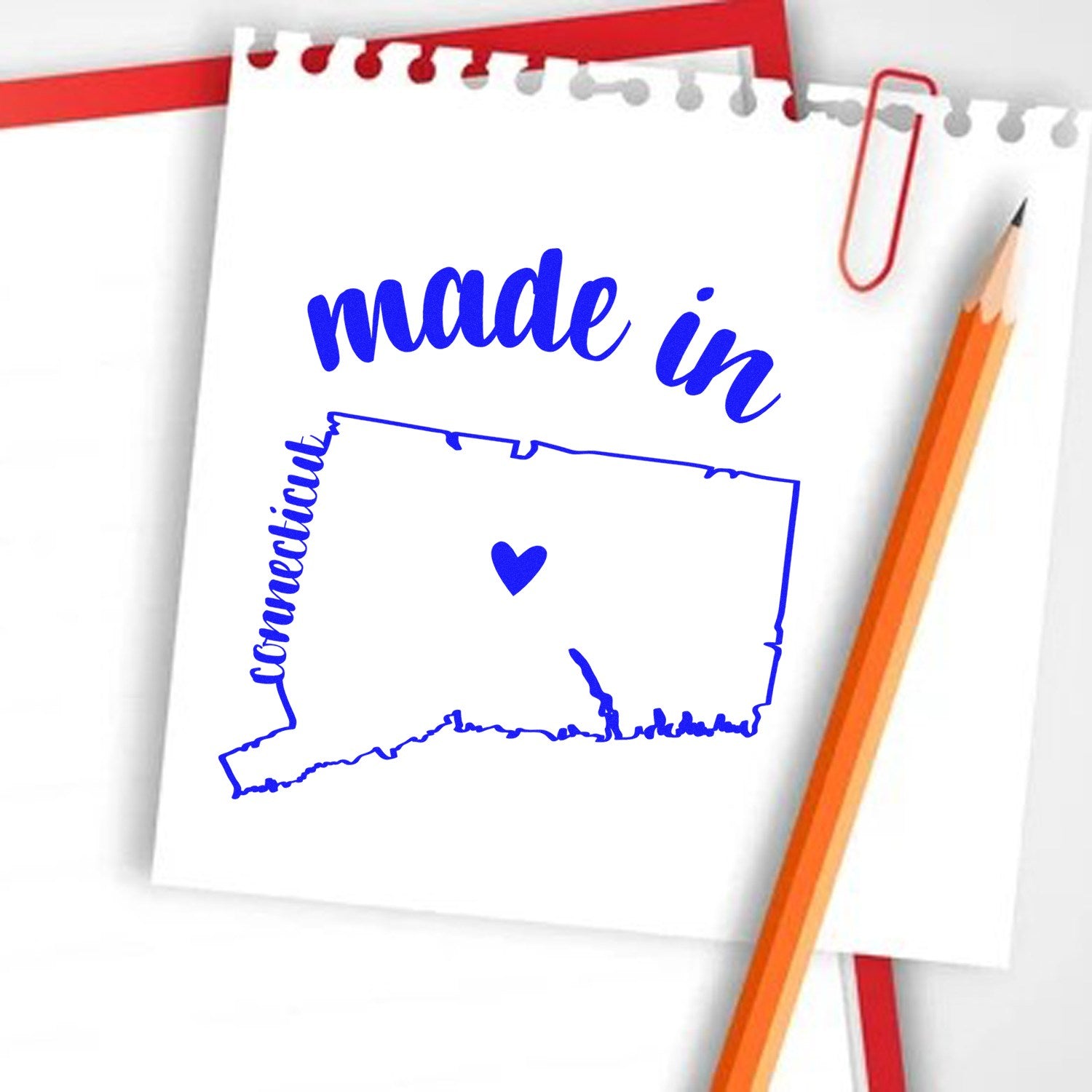 Self-Inking Handmade with Love in Connecticut Stamp on notepad with pencil, featuring a blue map outline of Connecticut and heart design. Perfect for crafts and personalized projects.