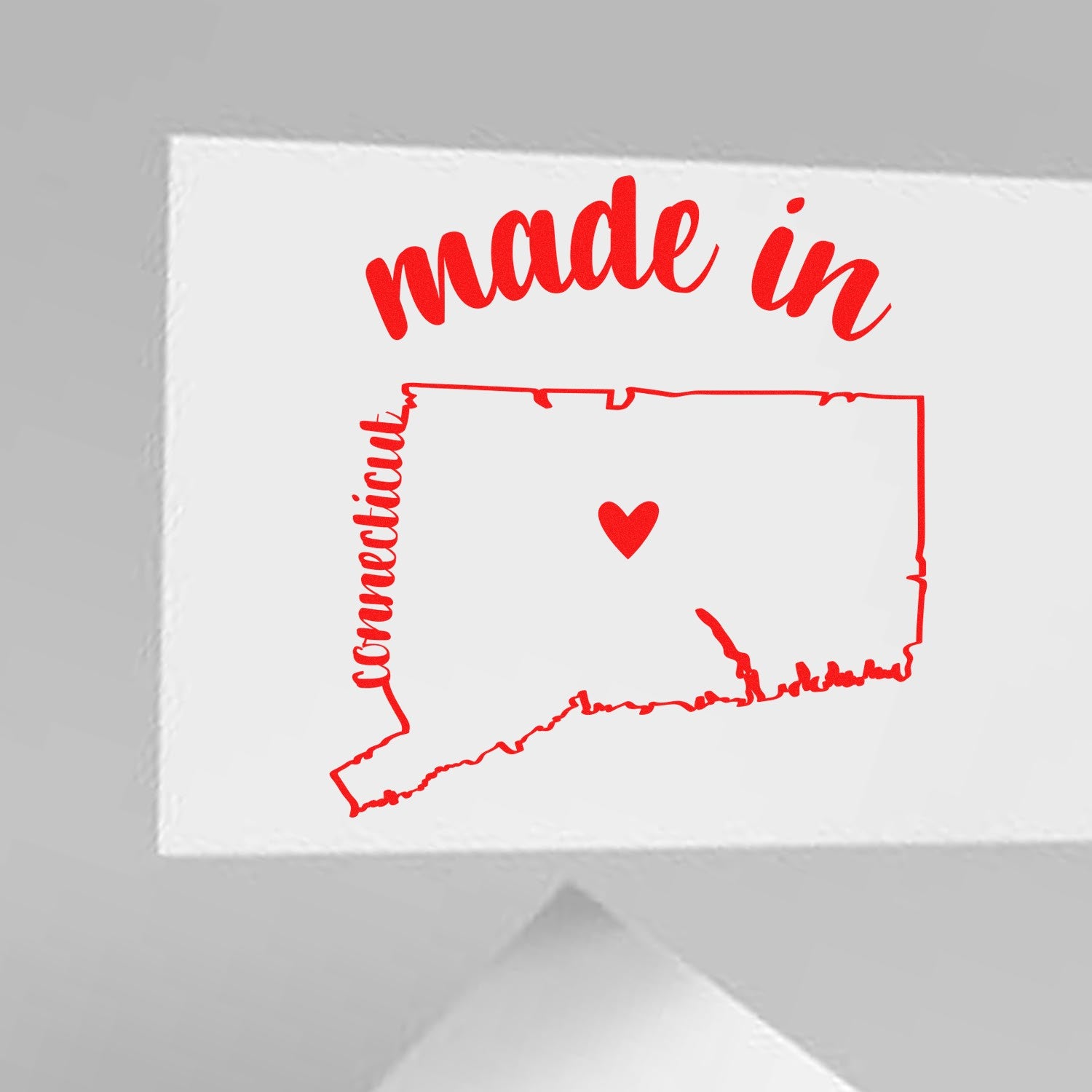 Made with Love in Connecticut Rubber Stamp featuring a red outline of Connecticut with a heart, and 'made in' text, perfect for crafts and gifts. Ideal for adding a personal touch.