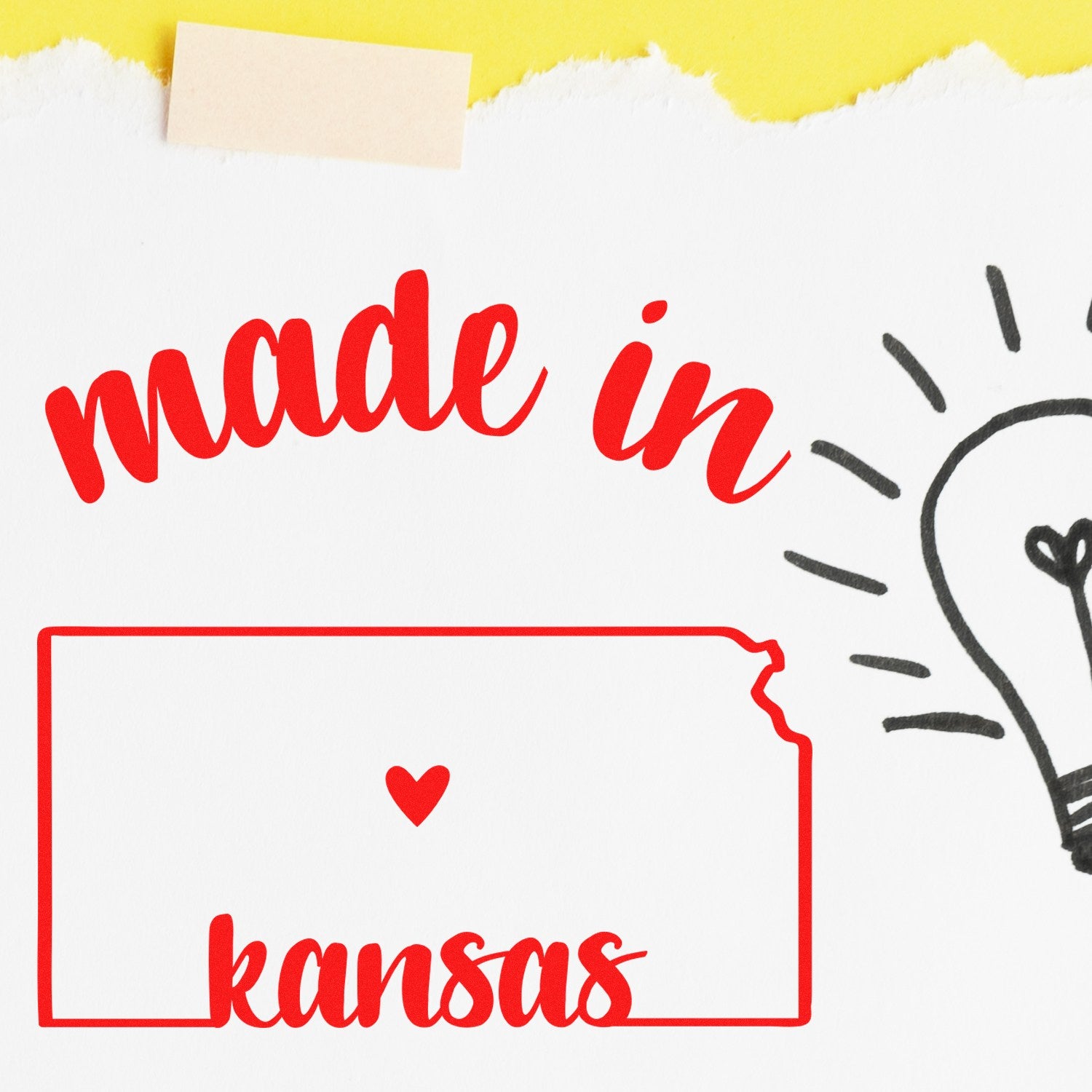 Self-Inking Handmade with Love in Kansas Stamp featuring red text 'made in kansas' with a heart and lightbulb design on a torn paper background.