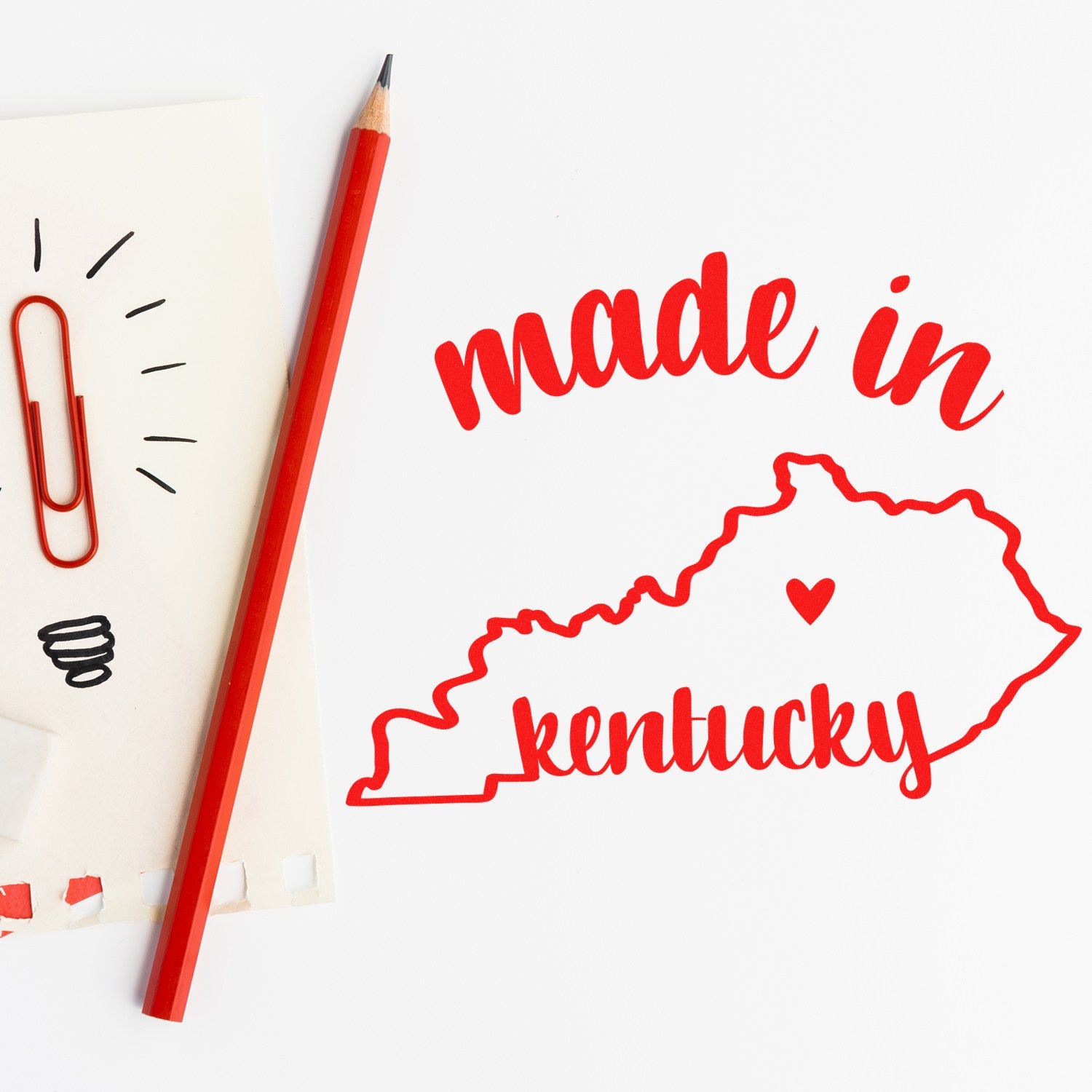 Slim Pre-Inked Stamp Kentucky Made in Stamp featuring a red outline of Kentucky with made in text, a heart, and a red pencil on a white background. Perfect for crafts and personalization.