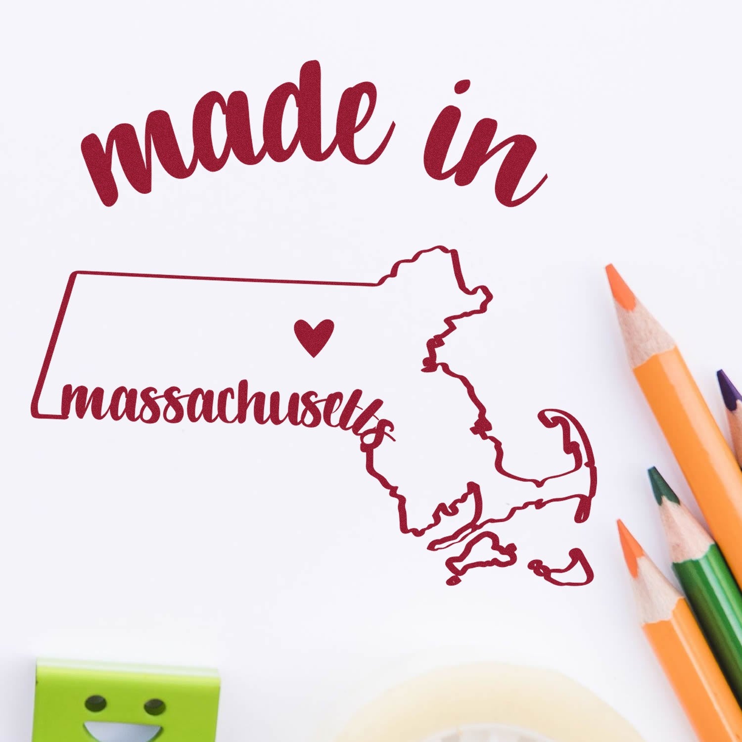 Self-Inking Handmade with Love in Massachusetts Stamp featuring a red outline of Massachusetts with a heart, surrounded by colorful pencils on a white background.