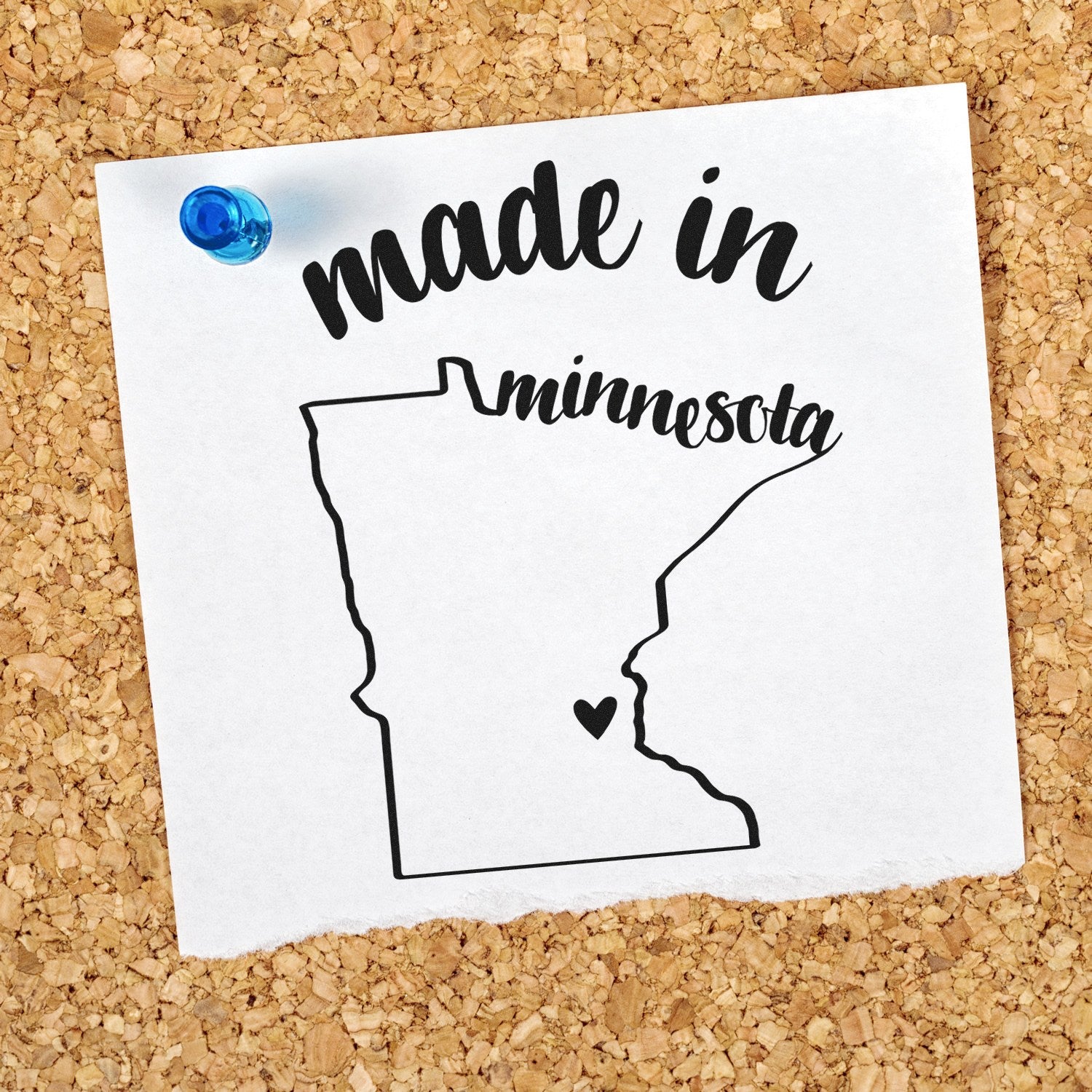 Made with Love in Minnesota Rubber Stamp on corkboard, featuring a heart inside the state outline and stylish script text. Perfect for crafts and gifts.