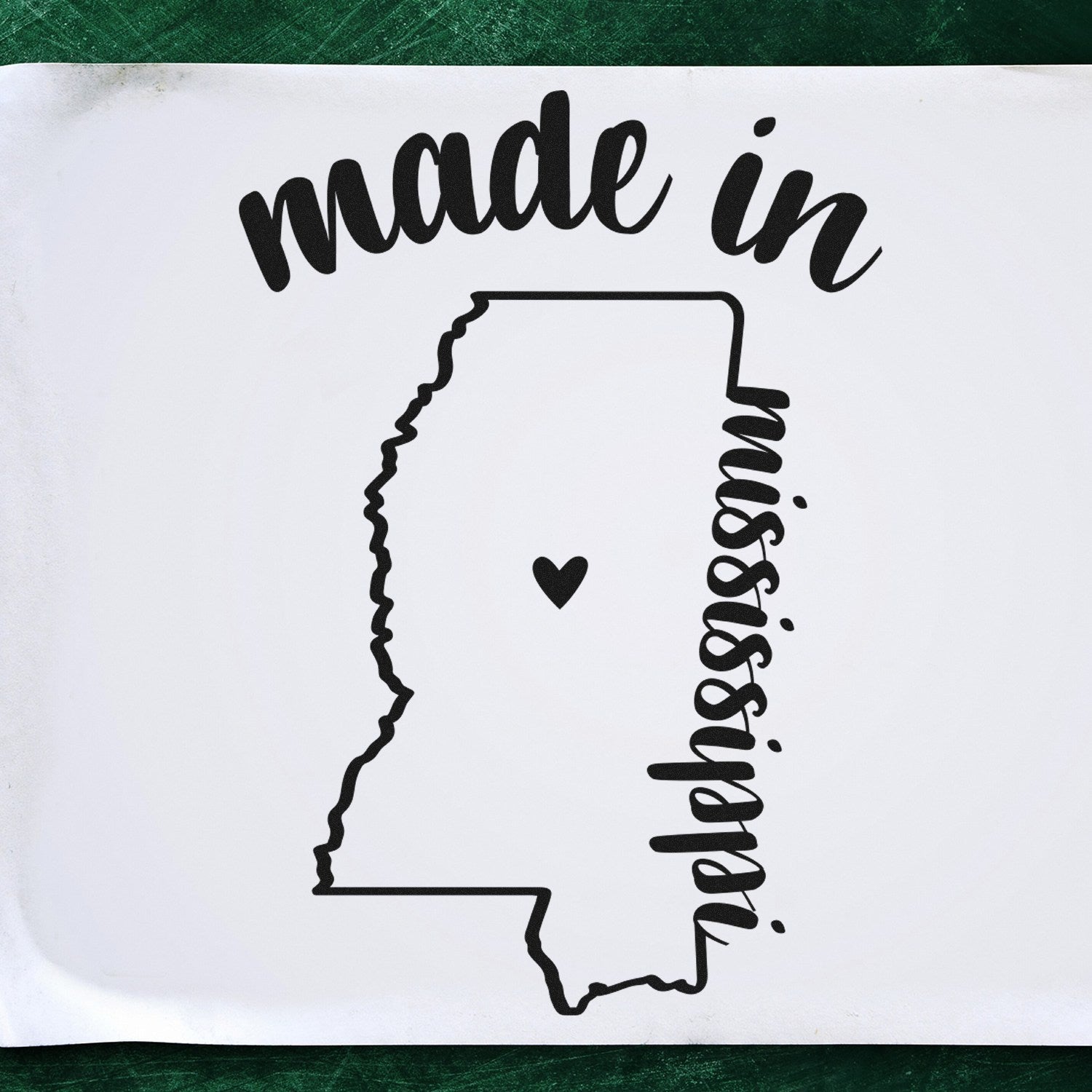 Made in Mississippi Stamp Pre-Inked featuring a black outline of Mississippi with a heart, and 'made in' text above. Ideal for crafts and branding. Pre-inked for convenience.