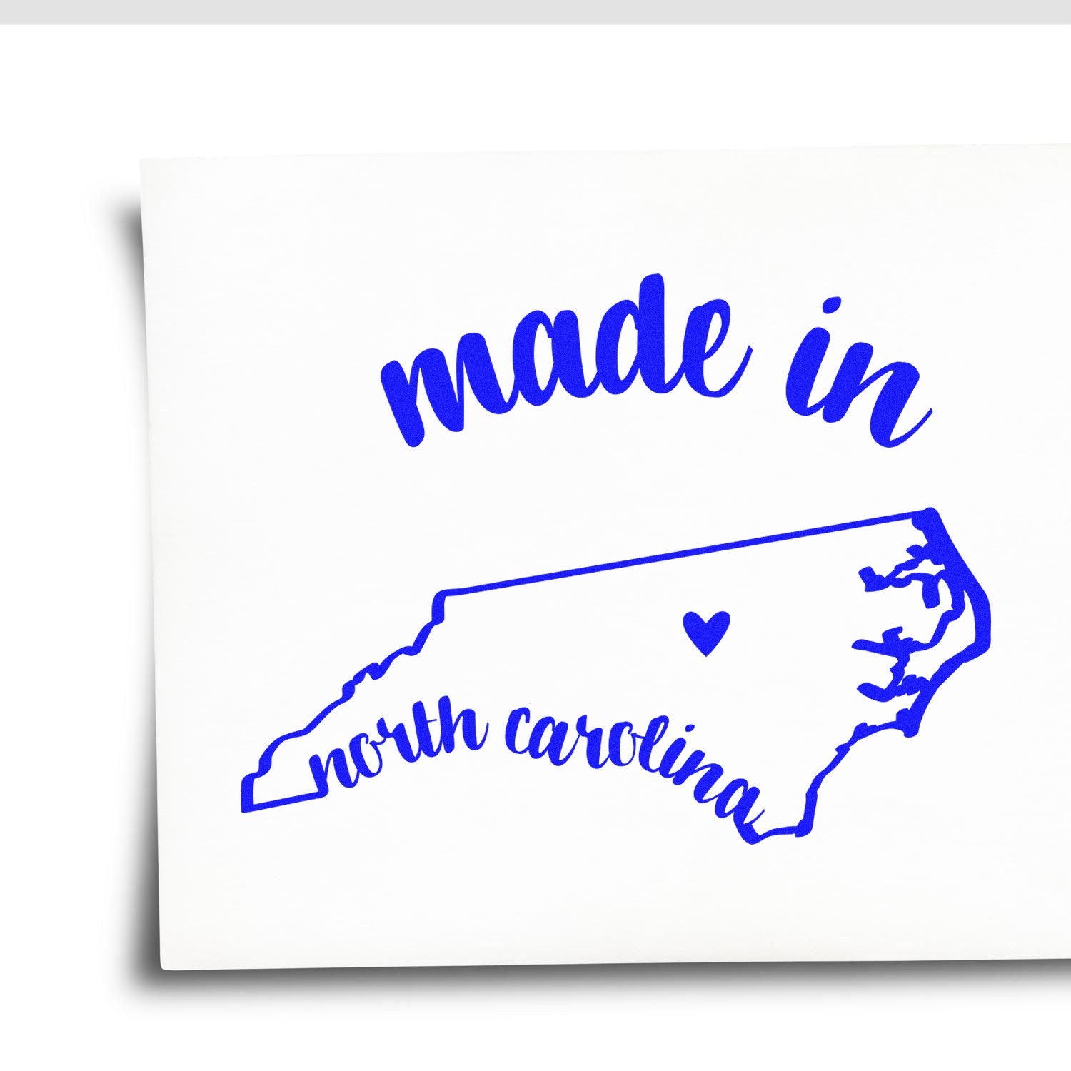 Made in North Carolina Stamp Pre-Inked featuring a blue outline of North Carolina with 'made in' and 'north carolina' text, perfect for adding a local touch to your projects.