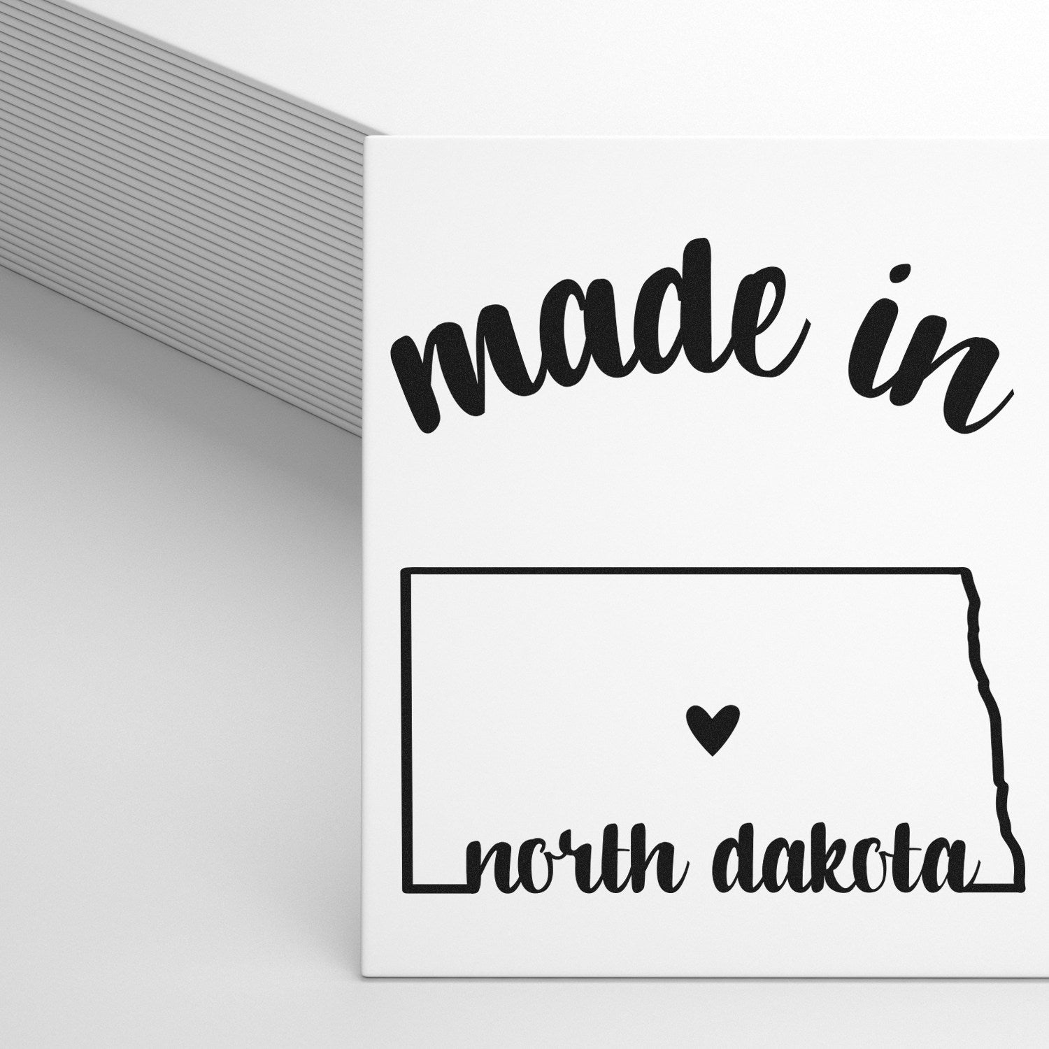 Made with Love in North Dakota Rubber Stamp featuring a heart and state outline, perfect for crafts and gifts. Black ink design on a white background.