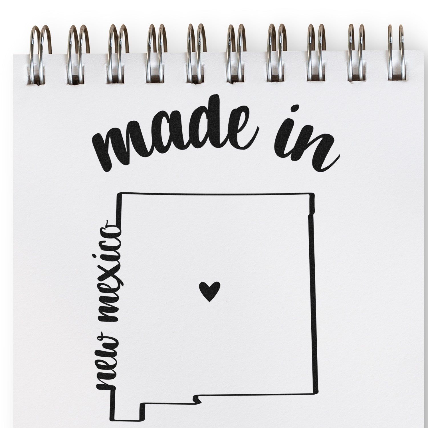 Self-Inking Handmade with Love in New Mexico Stamp on notepad, featuring a heart within the state outline. Perfect for crafts and gifts.