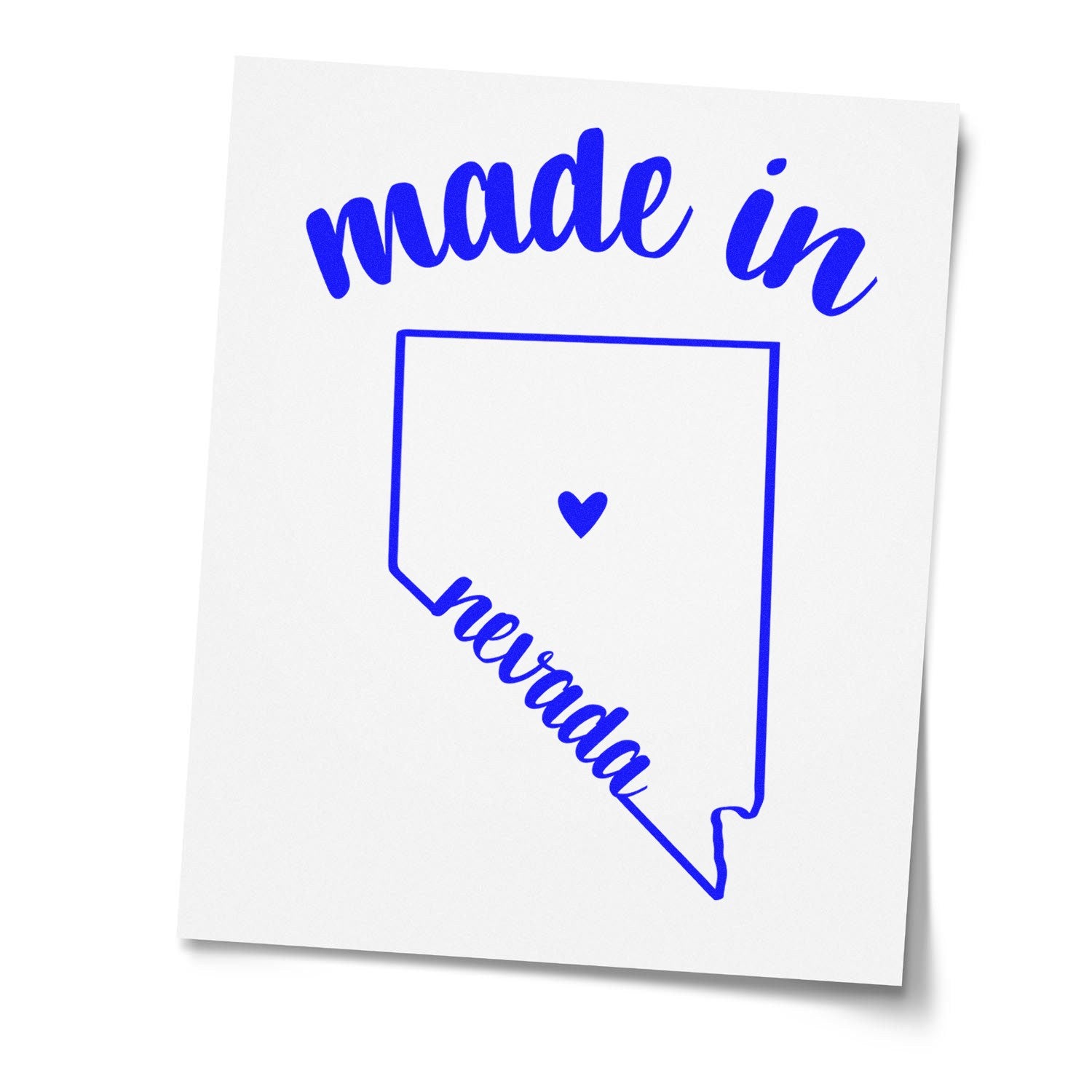 Made in Nevada Stamp Pre-Inked featuring a blue outline of Nevada with 'made in' text above and 'Nevada' below, centered with a heart symbol. Ideal for crafts and branding.