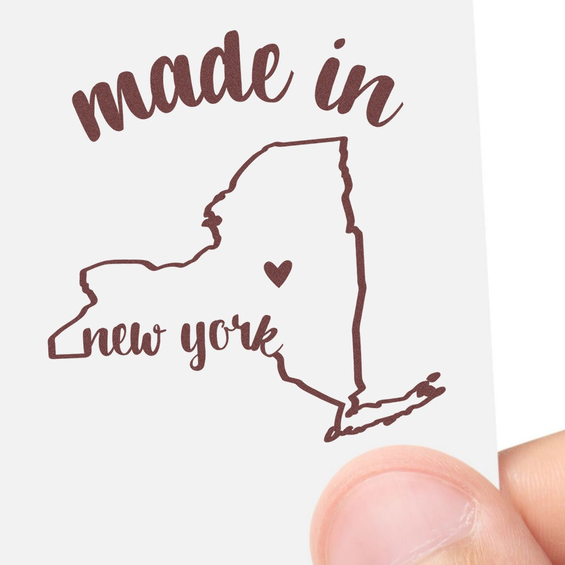 Self-Inking Handmade with Love in New York Stamp featuring a map outline of New York with 'made in new york' text and a heart symbol, held by a hand.