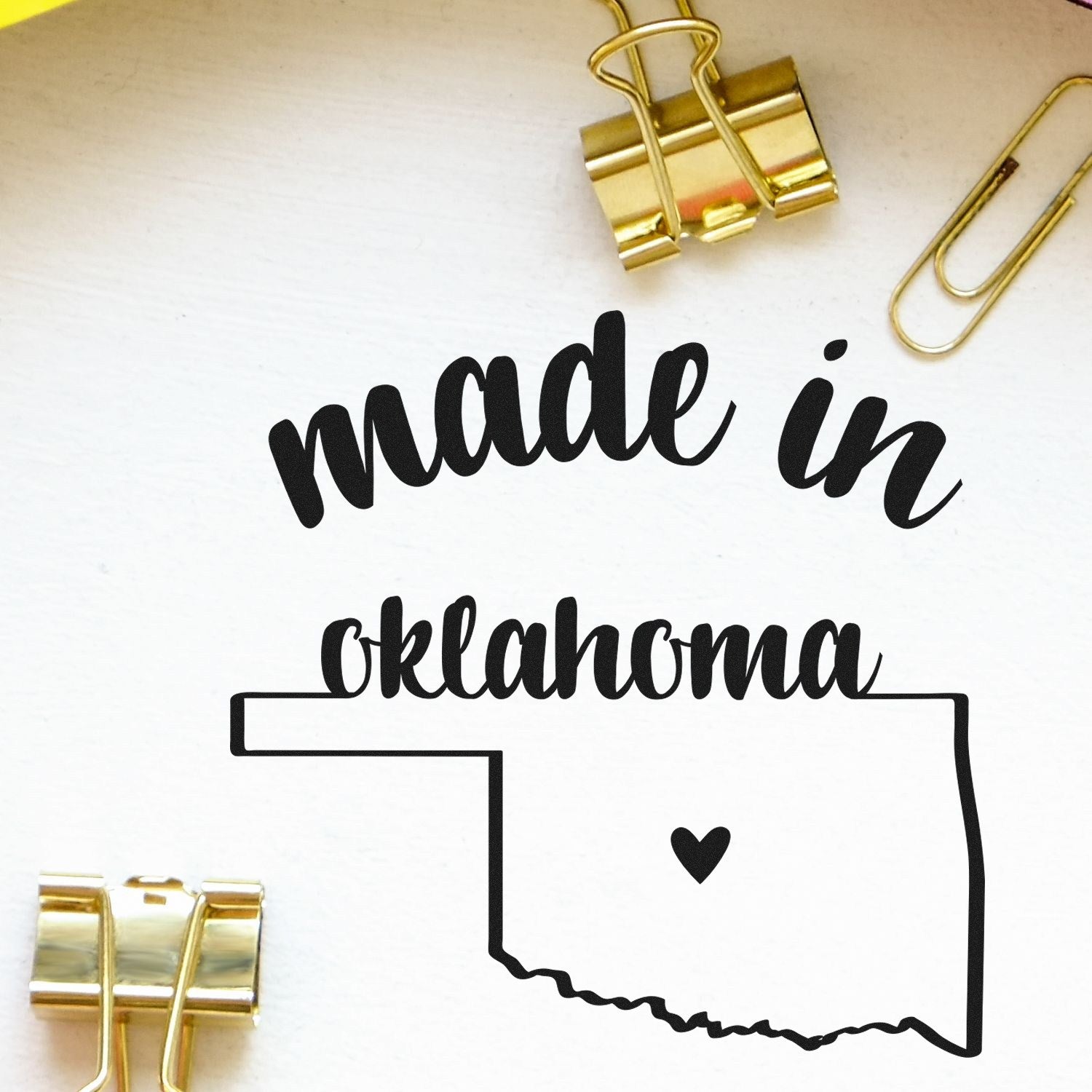 Made with Love in Oklahoma Rubber Stamp featuring state outline and heart, surrounded by gold clips on a white background.