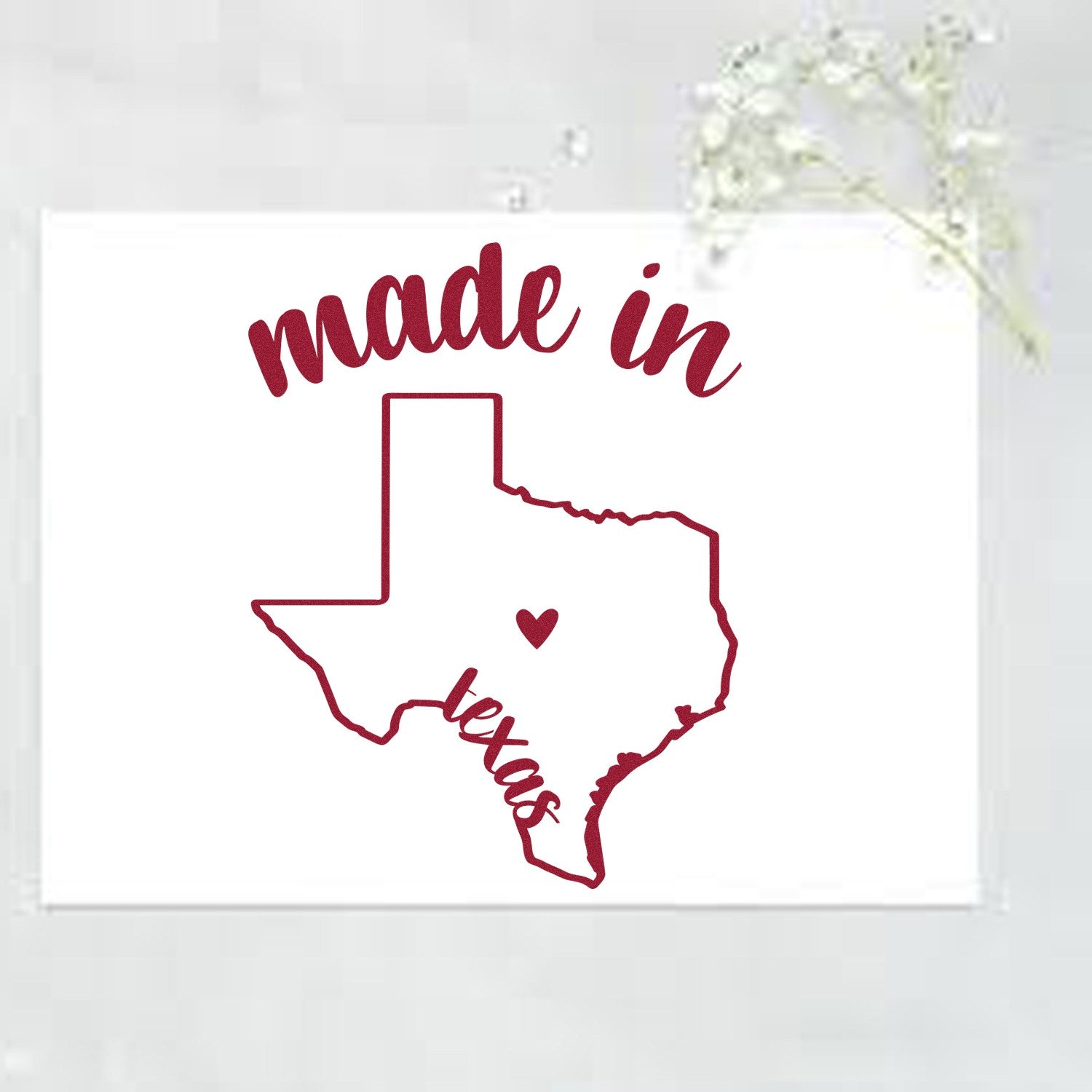 Slim Pre-Inked Stamp Texas Made in Stamp featuring a maroon outline of Texas with made in text above and texas below, centered on a white background with a small floral accent.