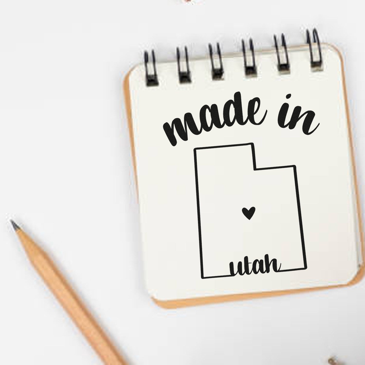 Made in Utah Stamp Pre-Inked on a notepad with a pencil, featuring a heart inside the Utah state outline and stylish lettering.