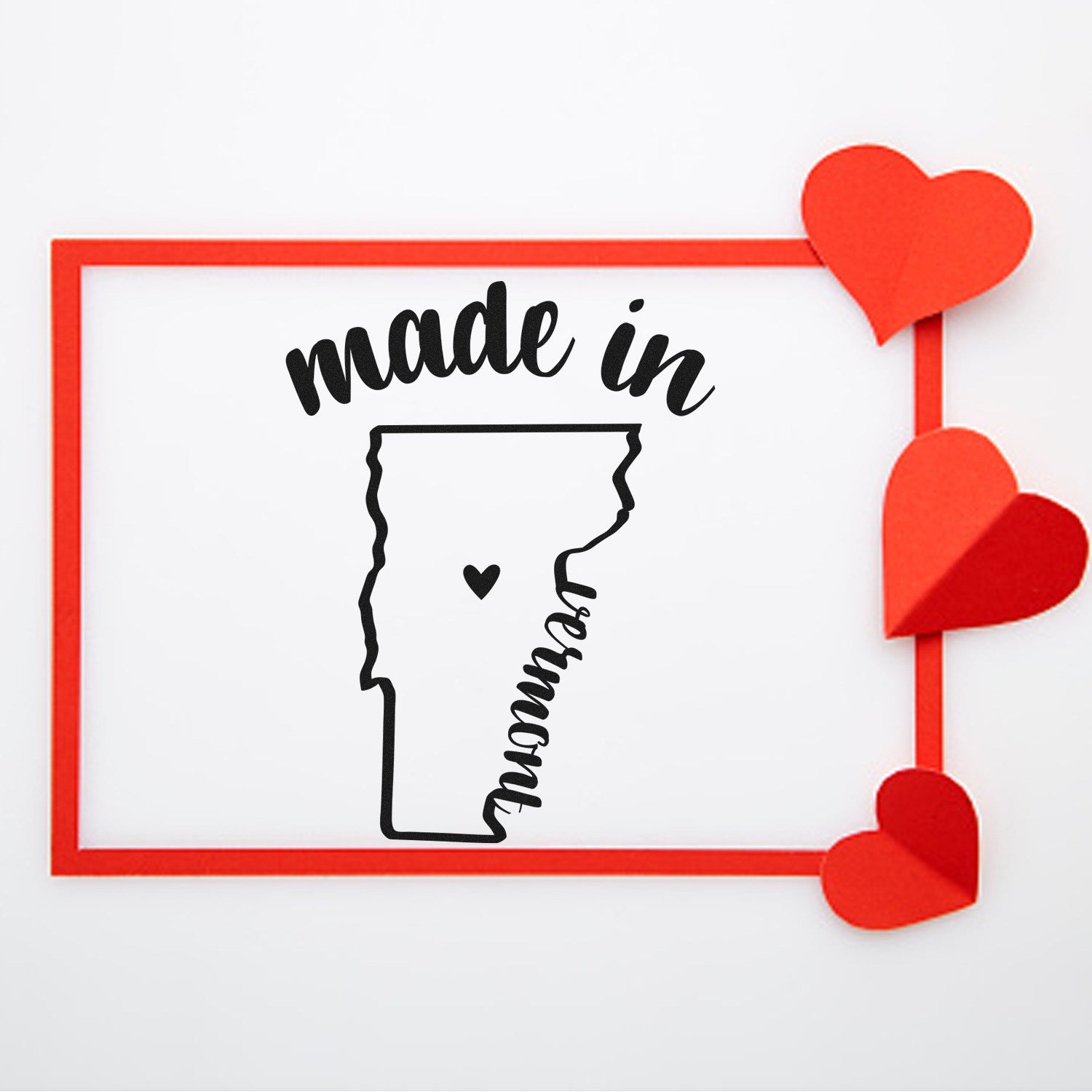 Self-Inking Handmade with Love in Vermont Stamp featuring a Vermont outline with a heart, surrounded by a red frame and hearts. Perfect for crafts and gifts.