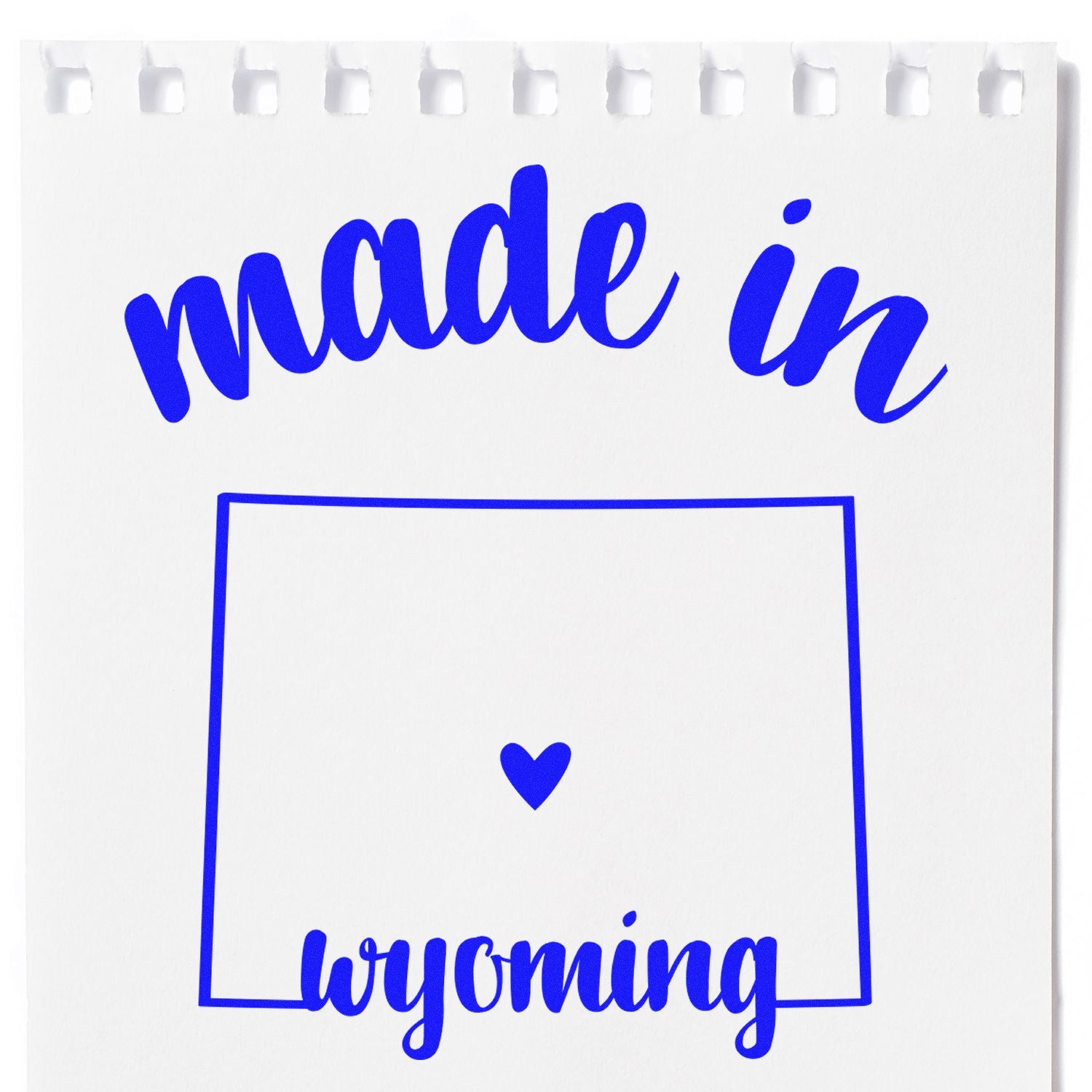 Self-Inking Handmade with Love in Wyoming Stamp featuring blue text and heart design on white paper. Perfect for adding a personal touch to crafts and gifts.