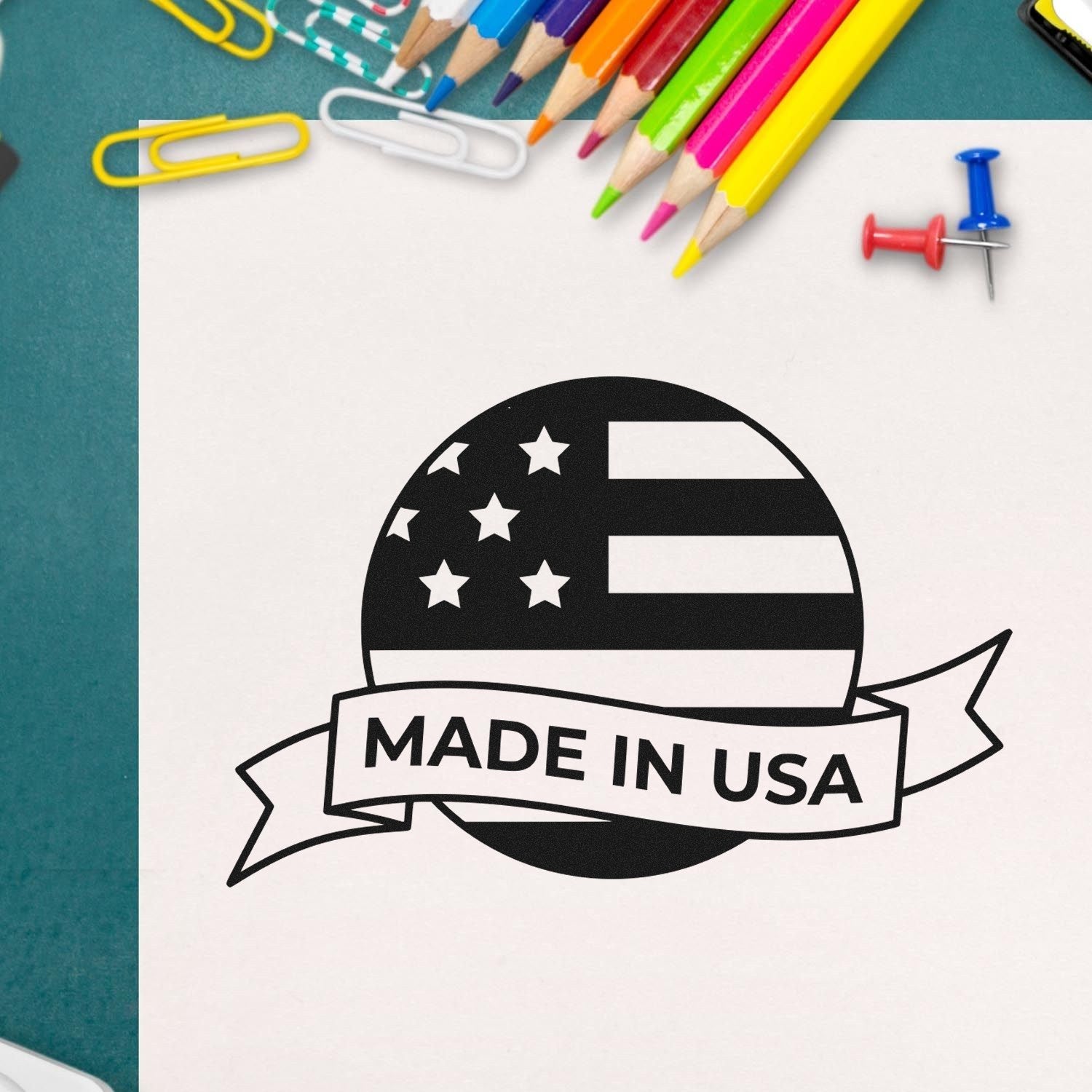 Image of the Slim Pre-Inked Patriot Seal Of Quality Stamp, featuring a Made in USA design with stars and stripes, surrounded by colorful stationery on a desk.