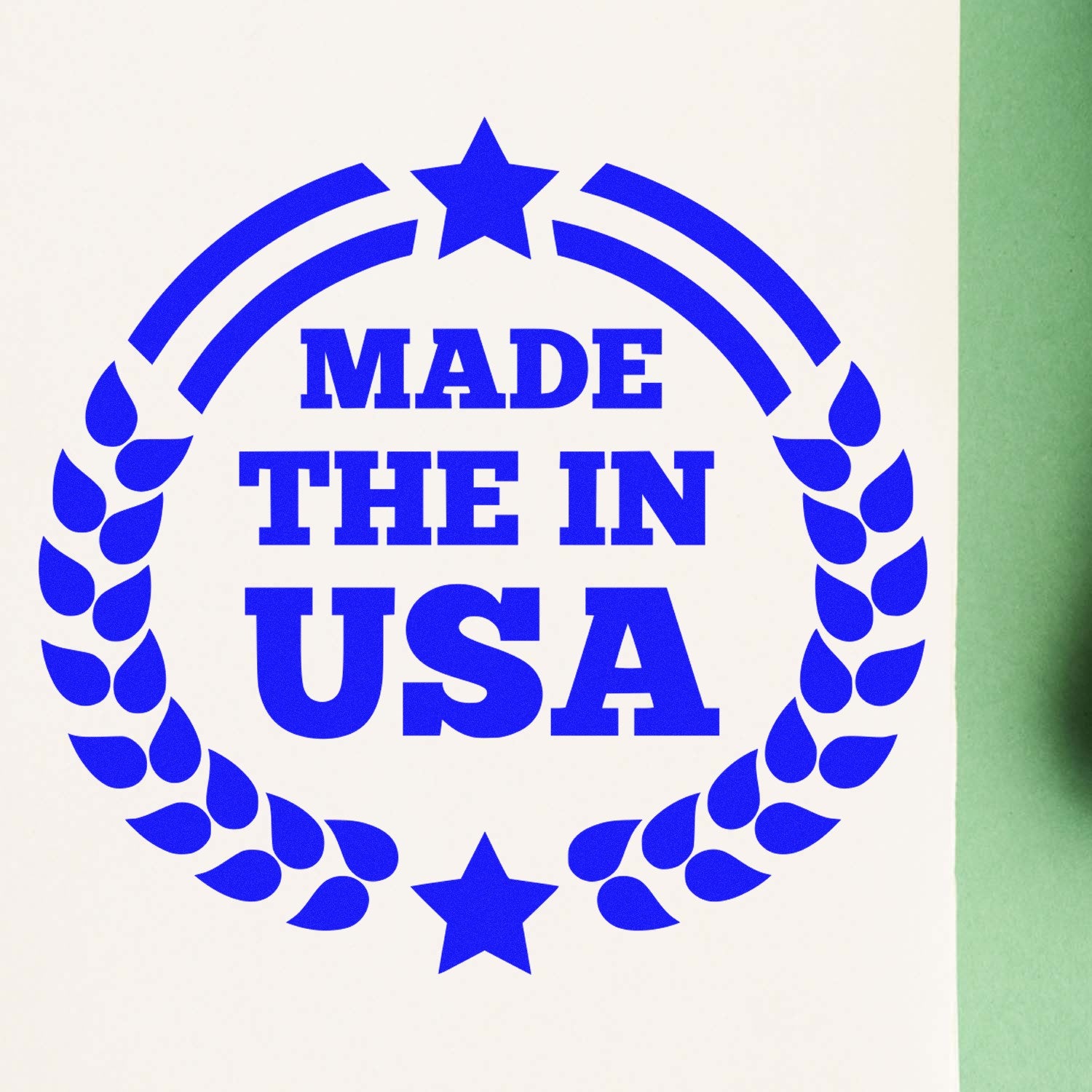 Wood Handle Made In The USA Proudly Rubber Stamp with blue ink design featuring stars and laurel wreath, stamped on white paper.