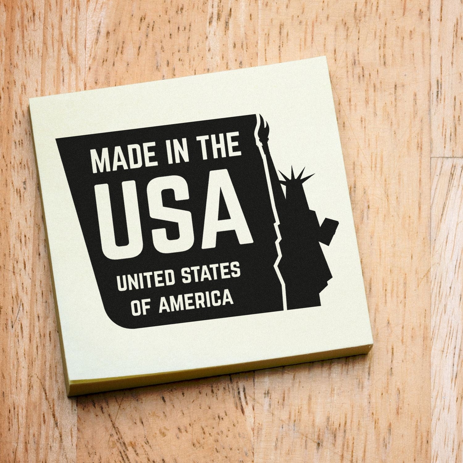 Self-Inking Liberty Made USA Stamp on wooden surface, featuring bold 'Made in the USA' text with a silhouette of the Statue of Liberty.