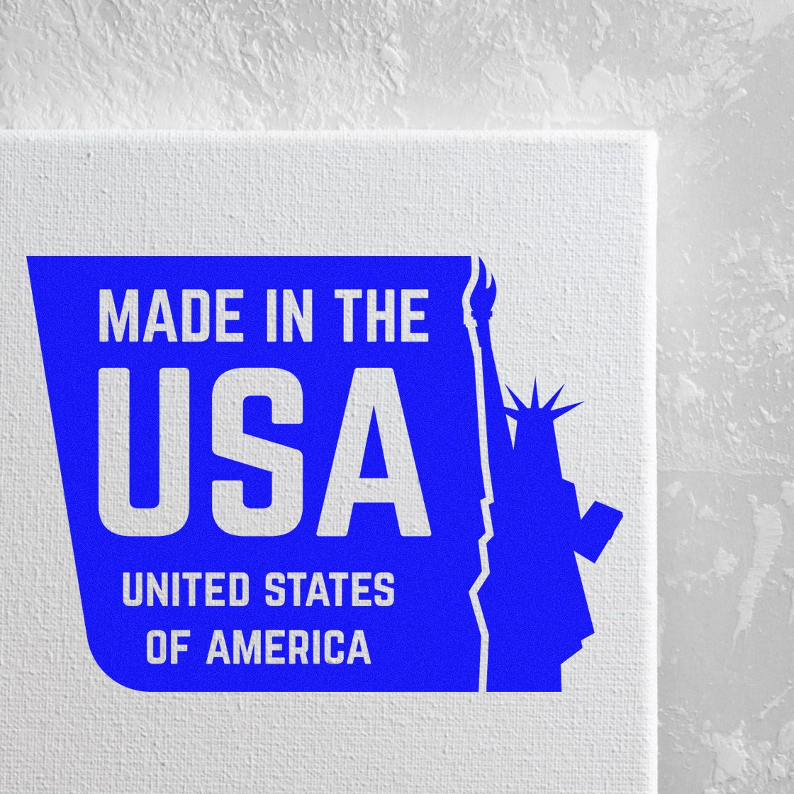 Self-Inking Liberty Made USA Stamp with blue and white design, featuring the Statue of Liberty silhouette and 'Made in the USA' text on a textured background.