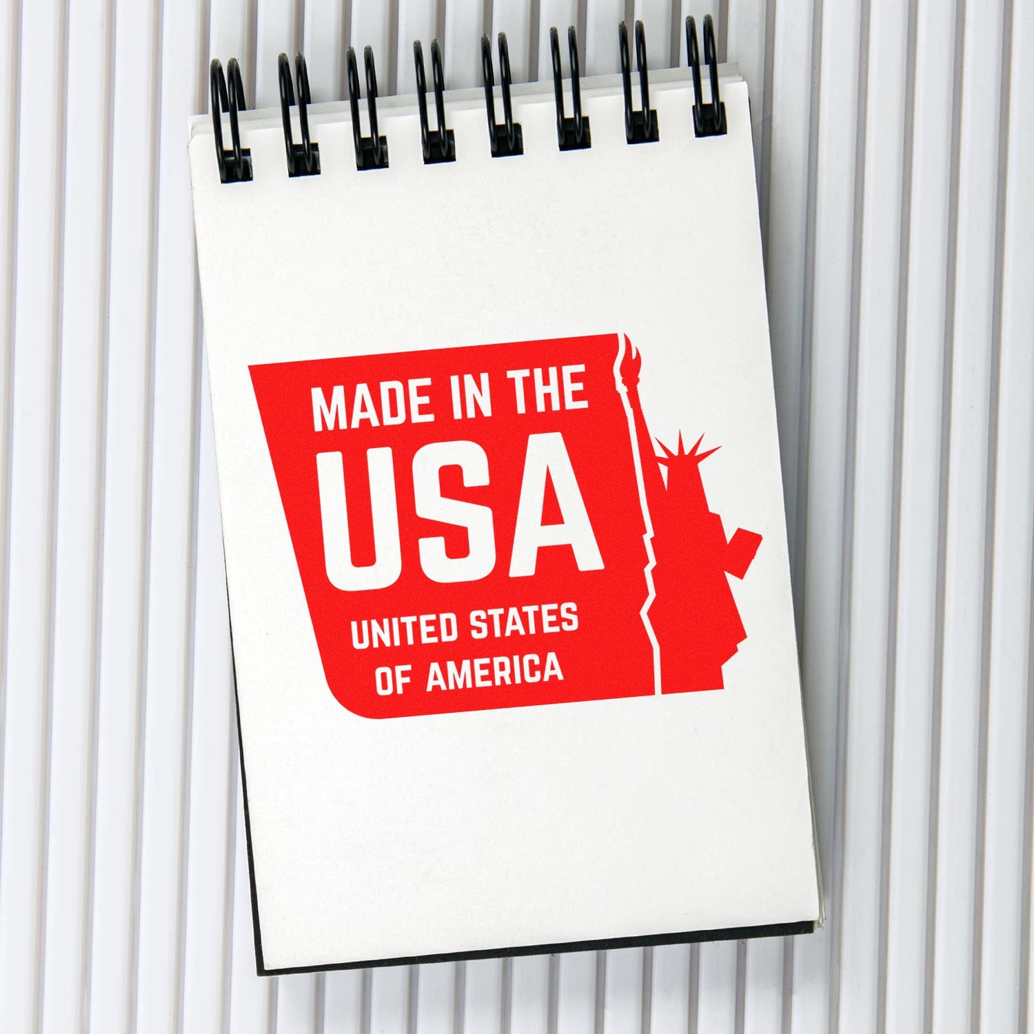 Self-Inking Liberty Made USA Stamp imprint on a notepad, featuring bold red text 'Made in the USA' with a silhouette of the Statue of Liberty.