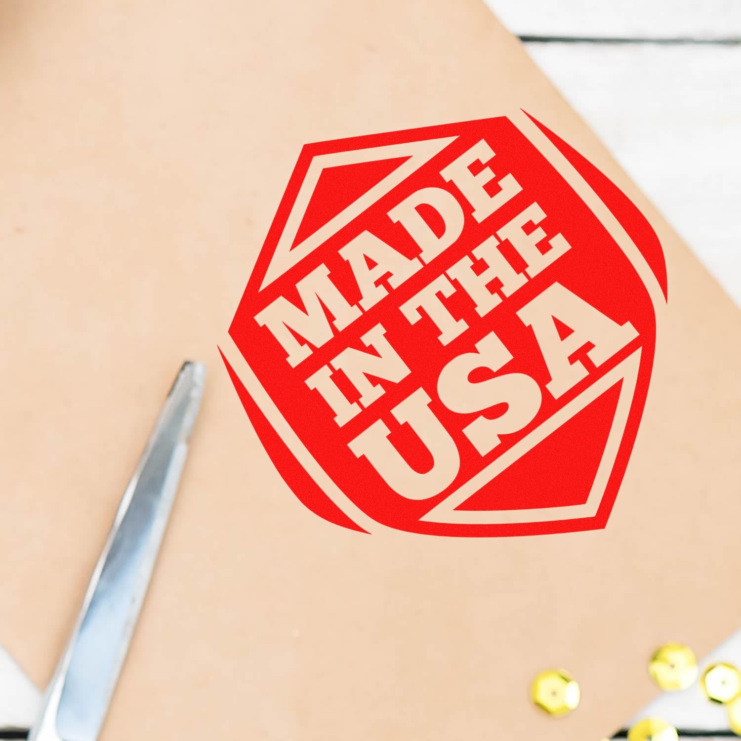 Self-Inking American Pride Seal Stamp imprinting 'Made in the USA' in bold red on paper, showcasing patriotic design. Ideal for crafts and official documents.