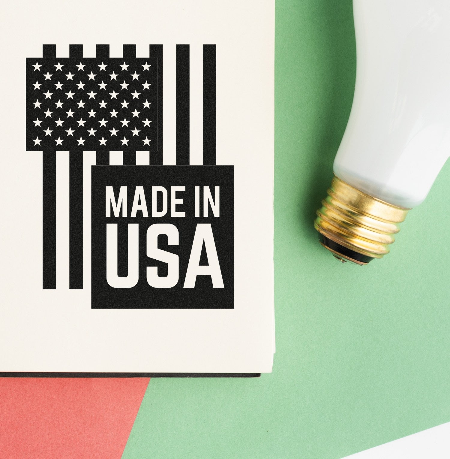 Wood Handle USA Patriotic Pride Rubber Stamp featuring a Made in USA design with stars and stripes, shown on a red and green background next to a light bulb.