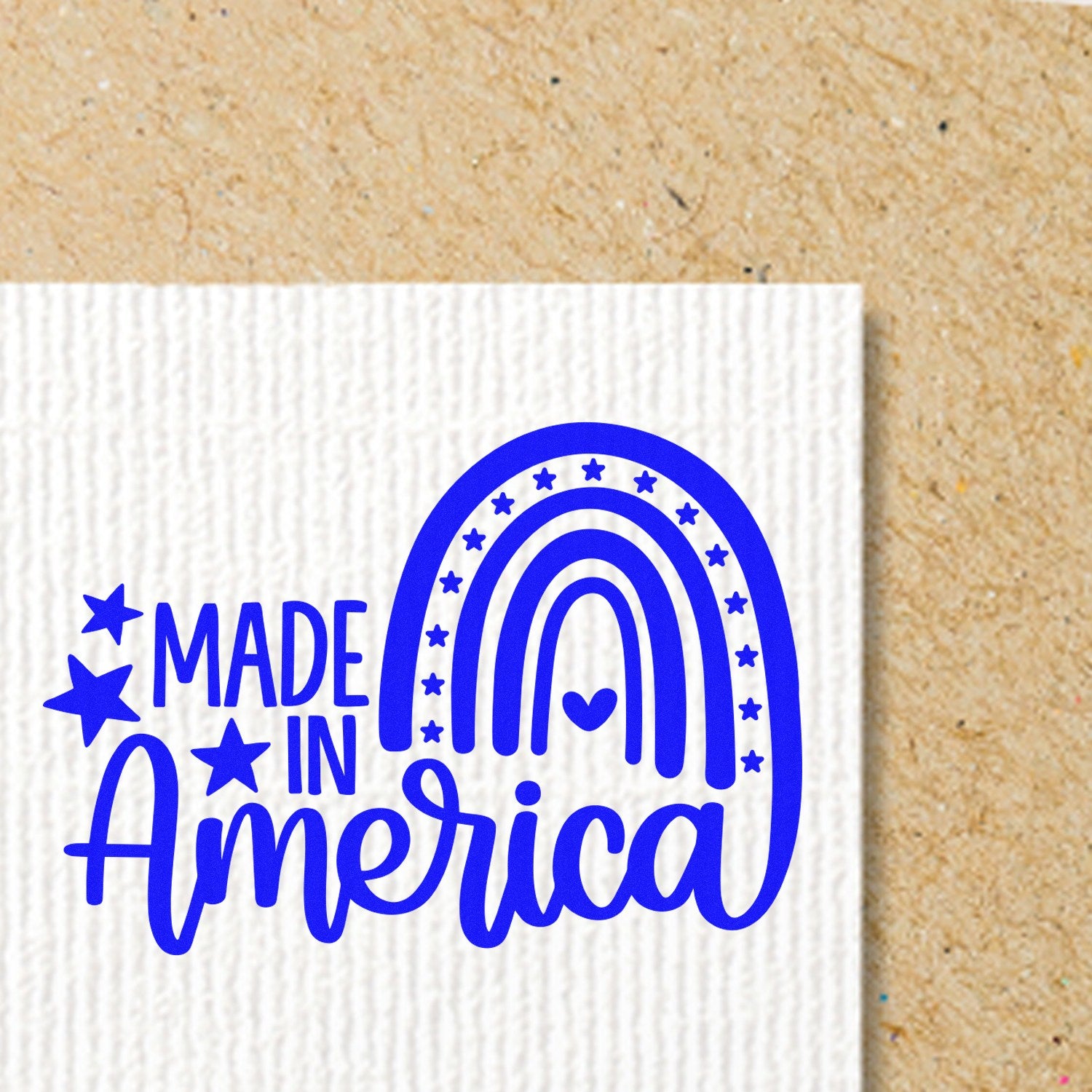 Wood Handle American Pride Rainbow Rubber Stamp imprint on paper, featuring a blue rainbow and 'Made in America' text with stars. Perfect for patriotic crafts and projects.