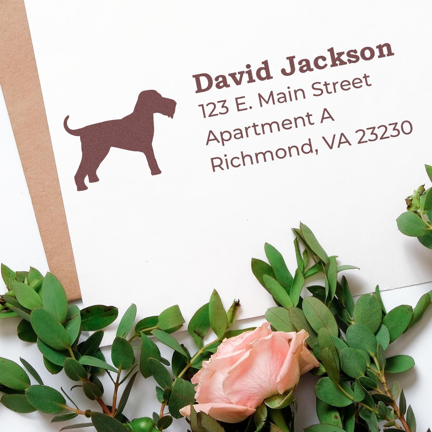 Slim Pre-Inked Airedale Terrier Address Stamp on an envelope with a silhouette of a dog, surrounded by green leaves and a pink rose, showcasing elegant and personalized mailing.