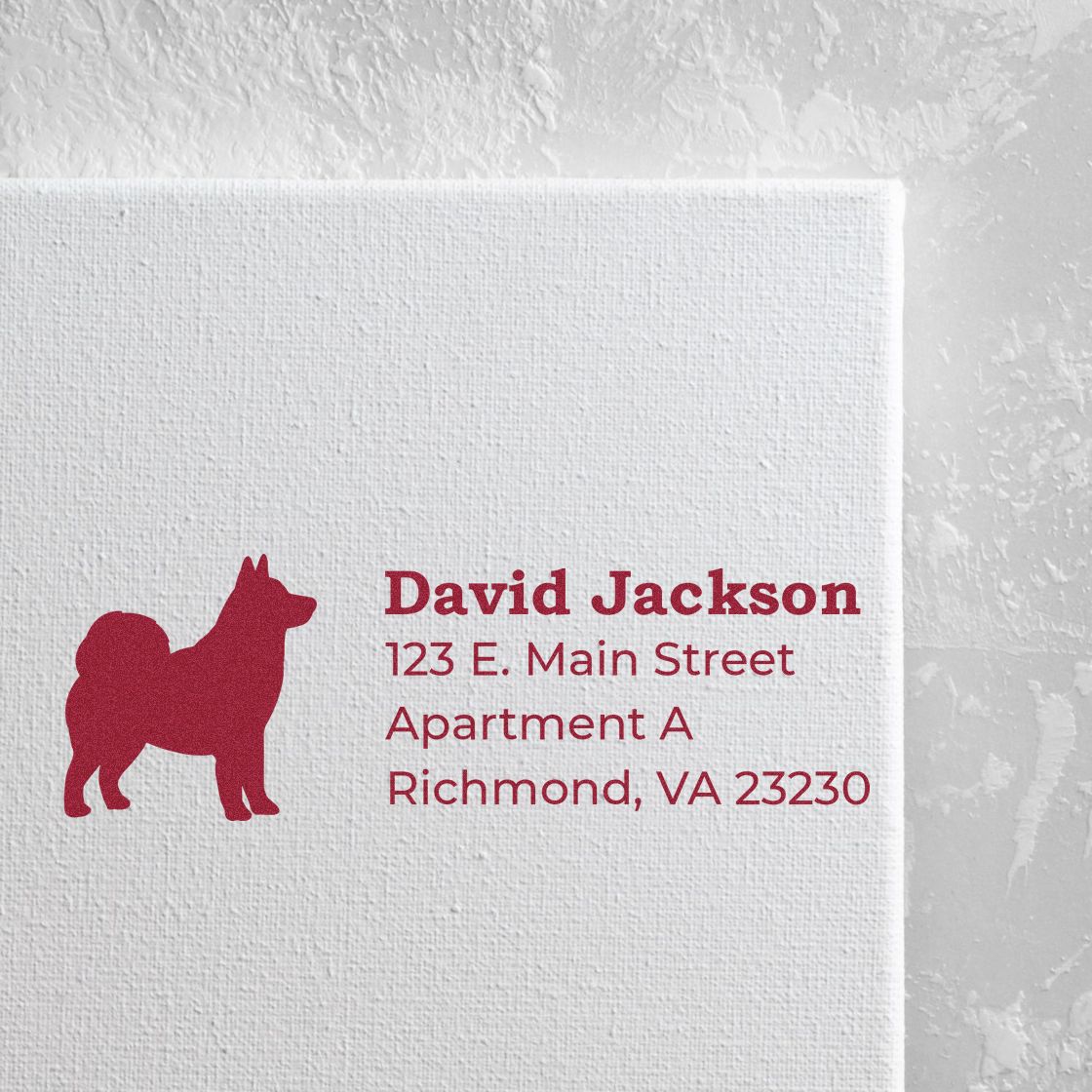 Alaskan Malamute Silhouette Address Rubber Stamp on white paper, featuring a red dog silhouette and sample address text in bold red font.